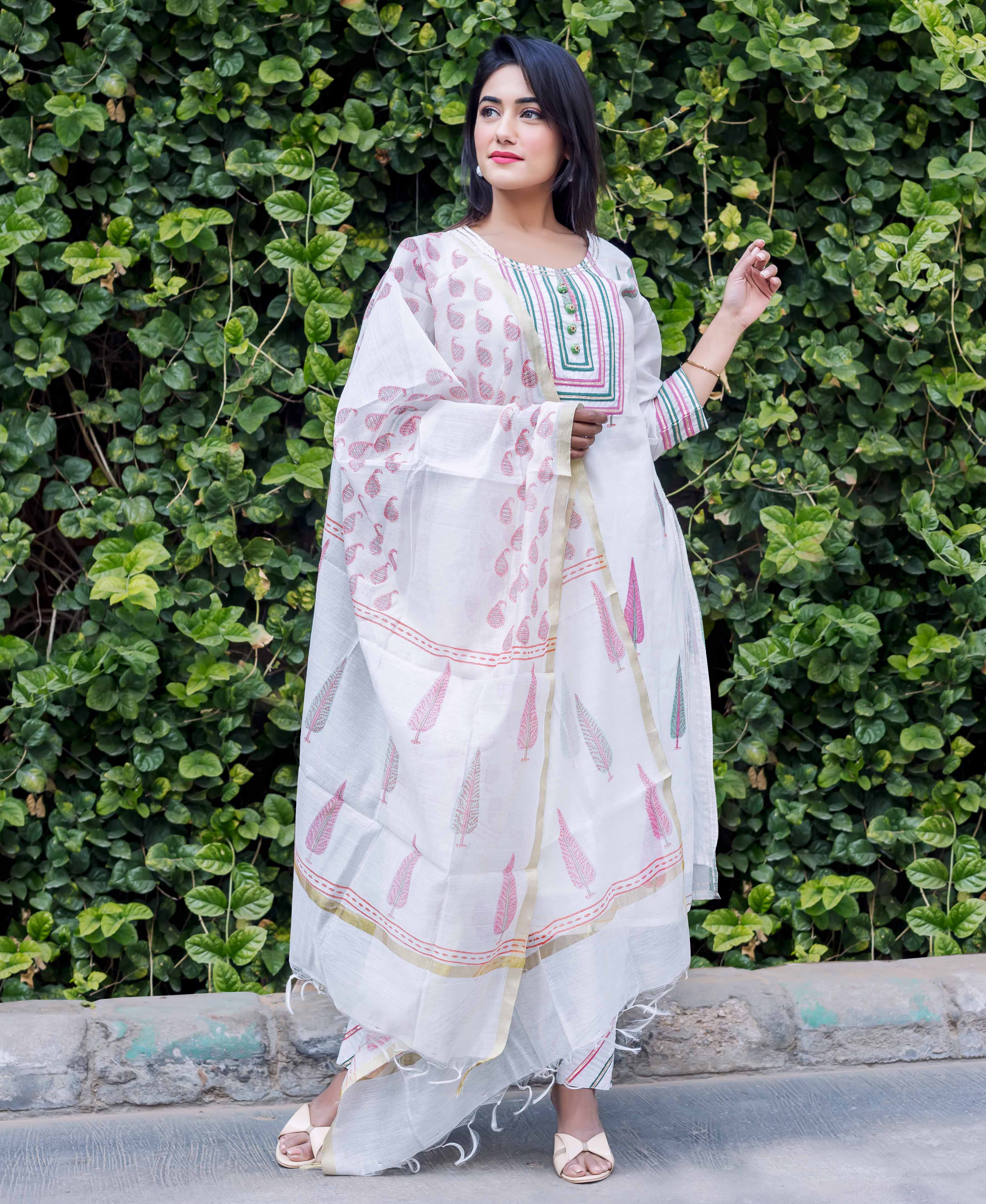 White Chanderi block printed kurta set on model with pink and green leaf patterns.