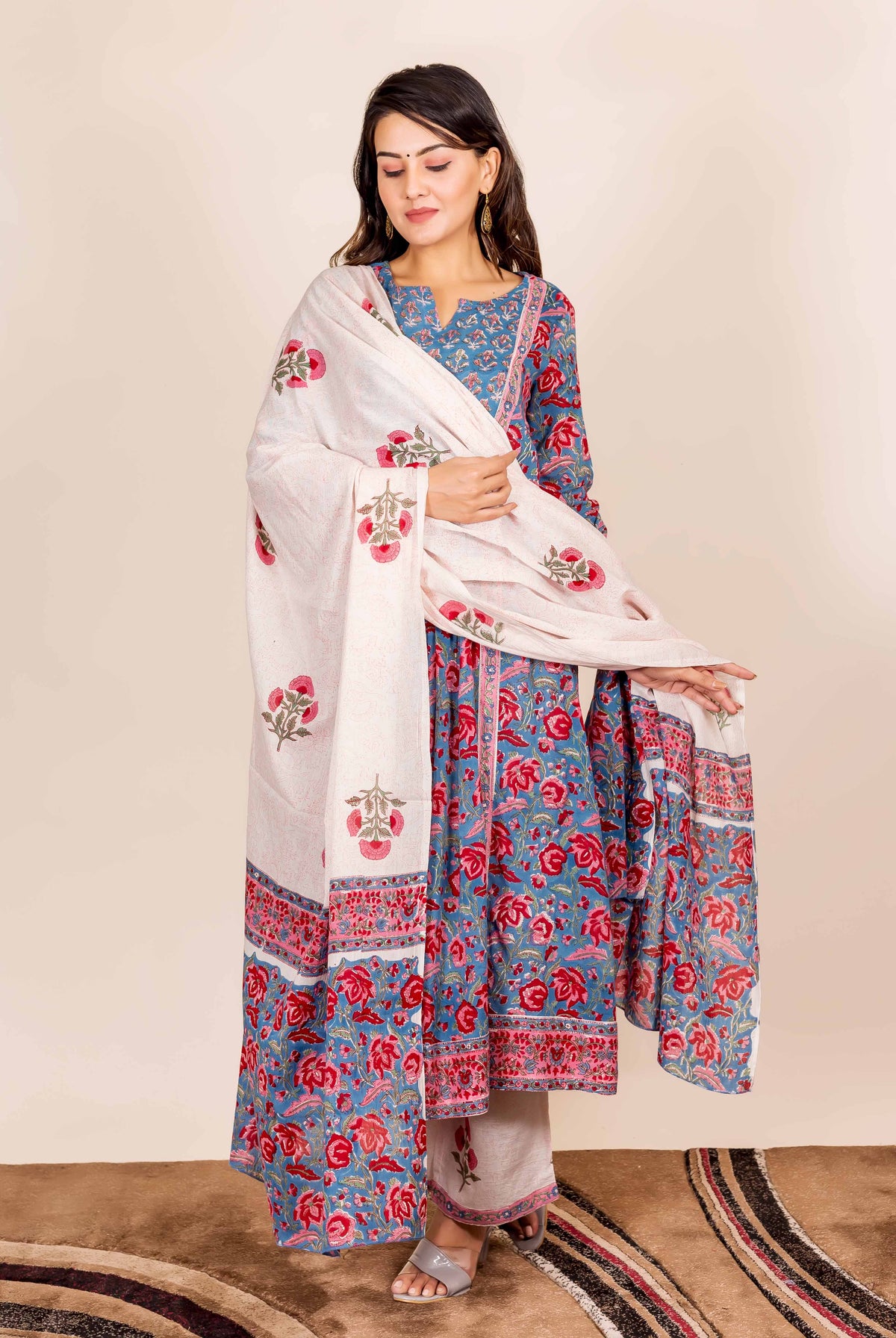 A model wearing a blue and red hand-block-printed kurta with a white dupatta.