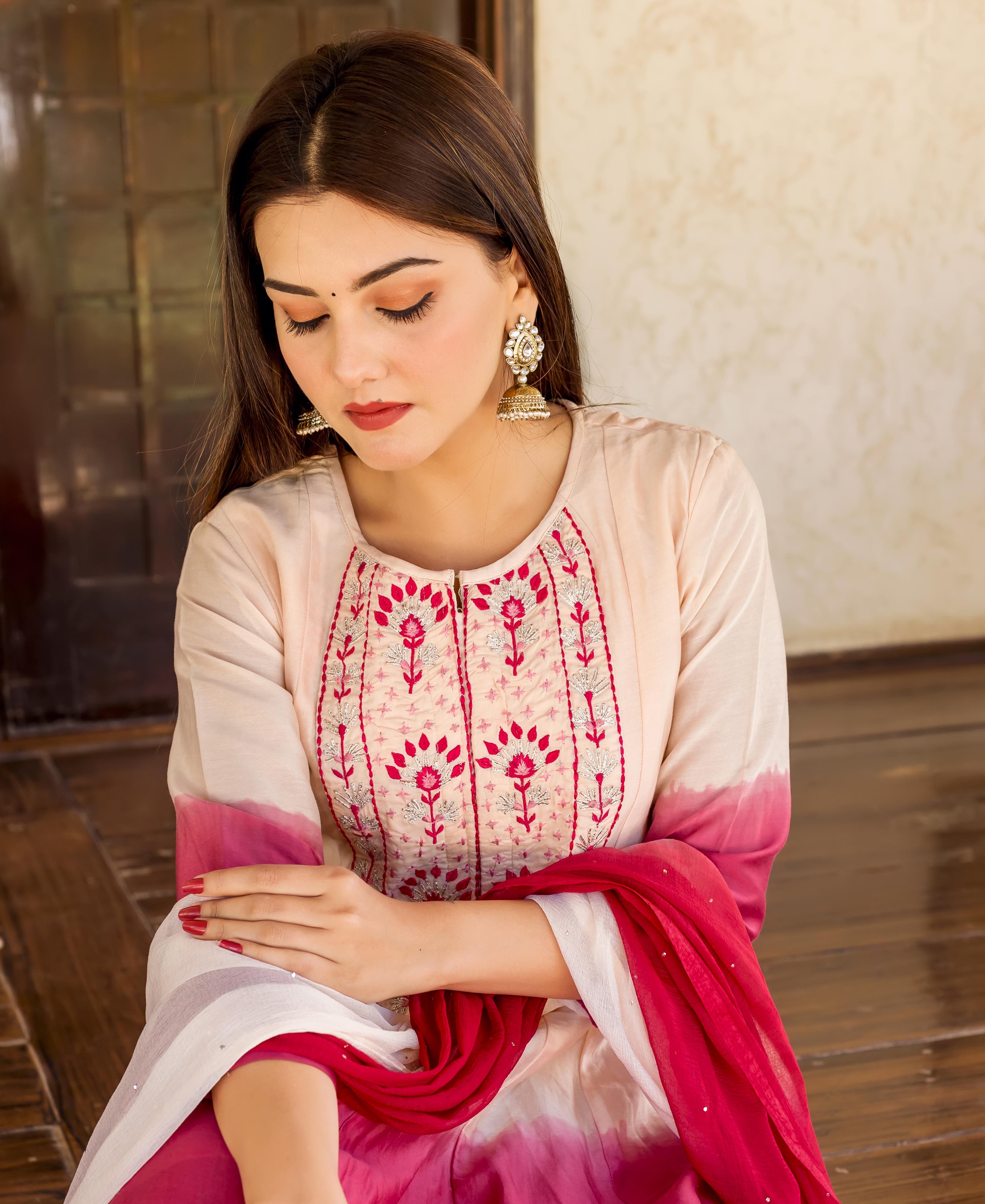 Woman in salmon burgundy ombre gotta embroidered kurta and draped matching dupatta.