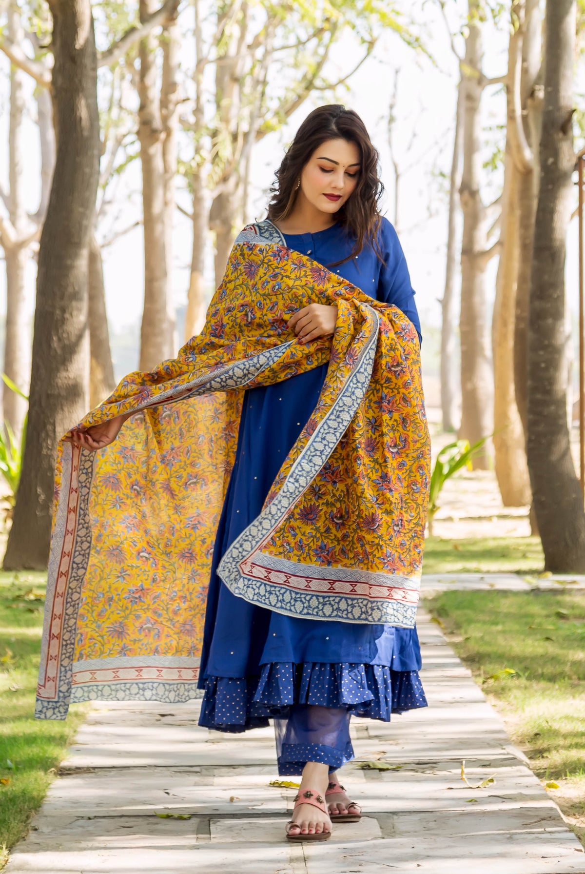 Model in azure blue layered kurta, polka dot pants, and yellow hand-block print dupatta.