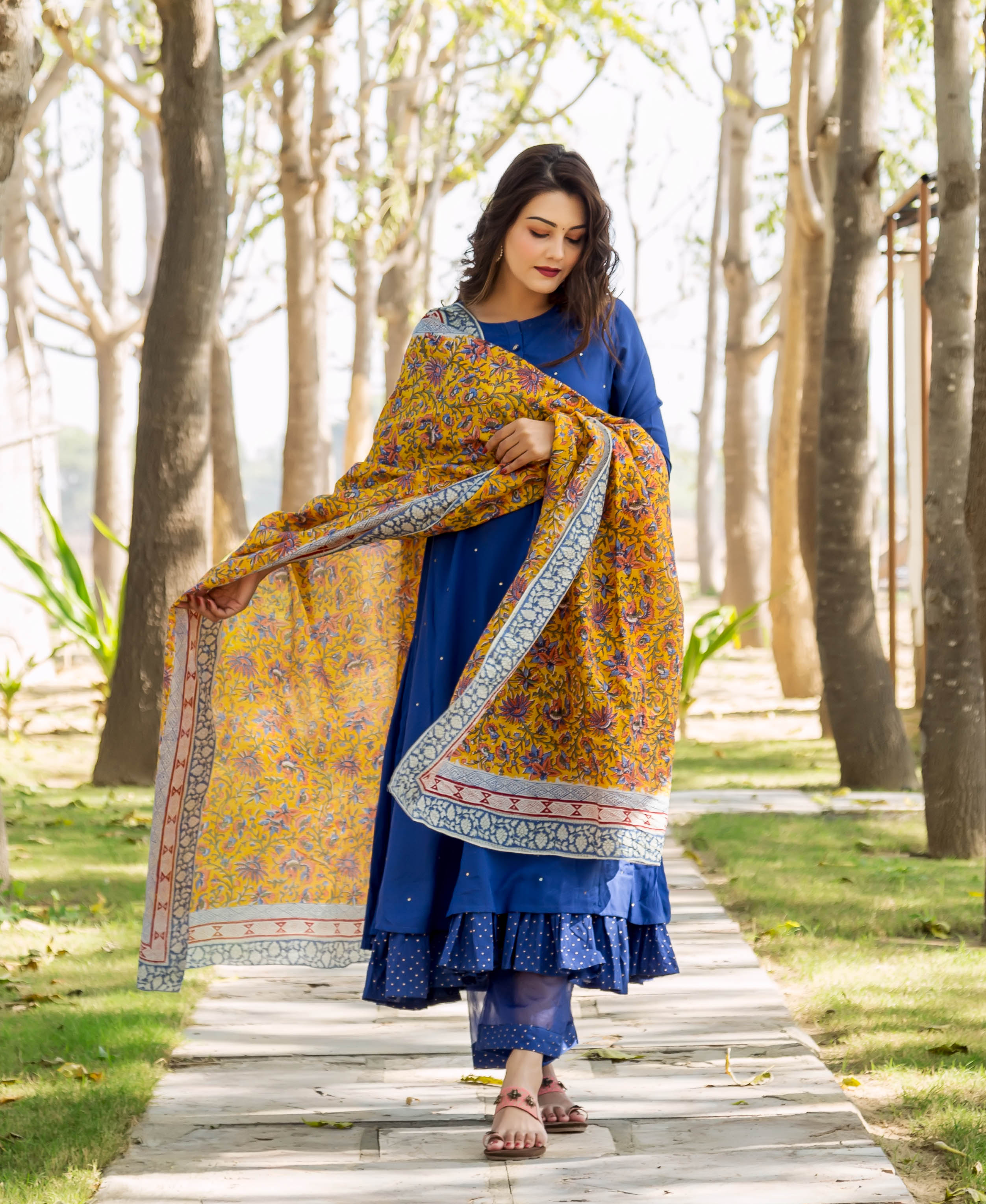 Model in azure blue layered kurta, polka dot pants, and yellow hand-block print dupatta.