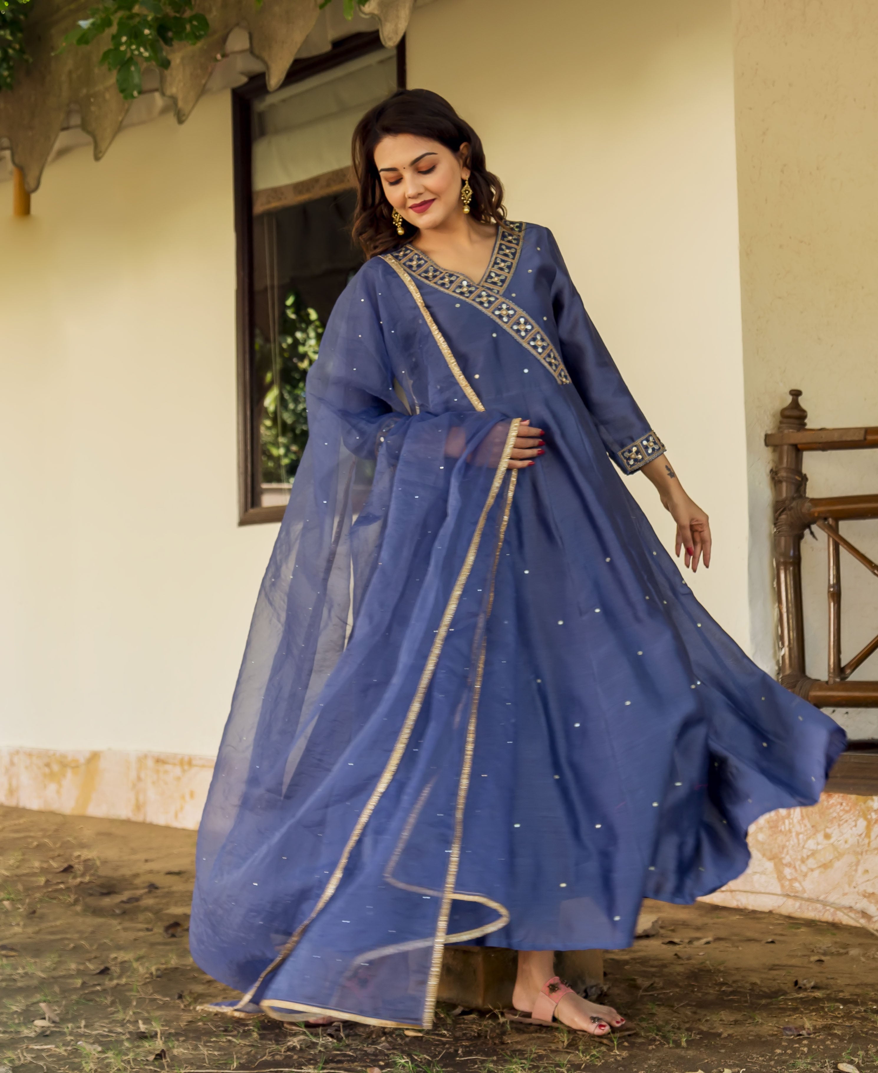 Full-length model wears a flowing steel blue hand-embroidered V-neck dress with matching sheer dupatta.