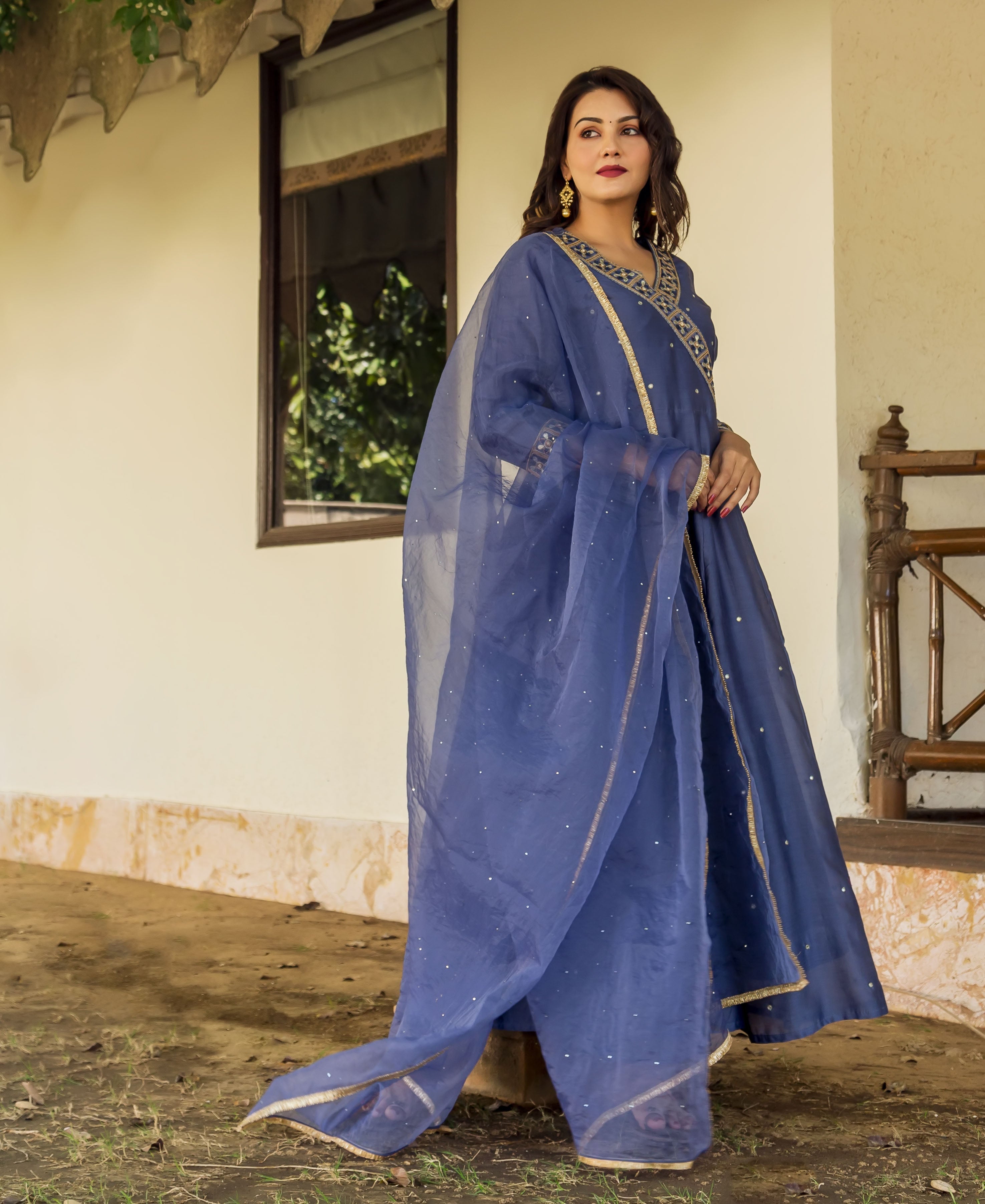 Full shot of a woman in a steel blue hand-embroidered Anarkali dress with matching dupatta.