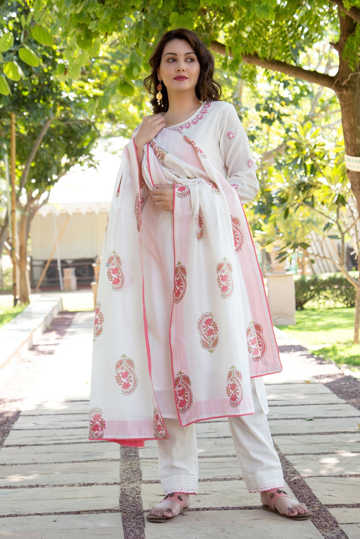 Full-length model in white kurta set with pink embroidered neckline and paisley block-printed dupatta.