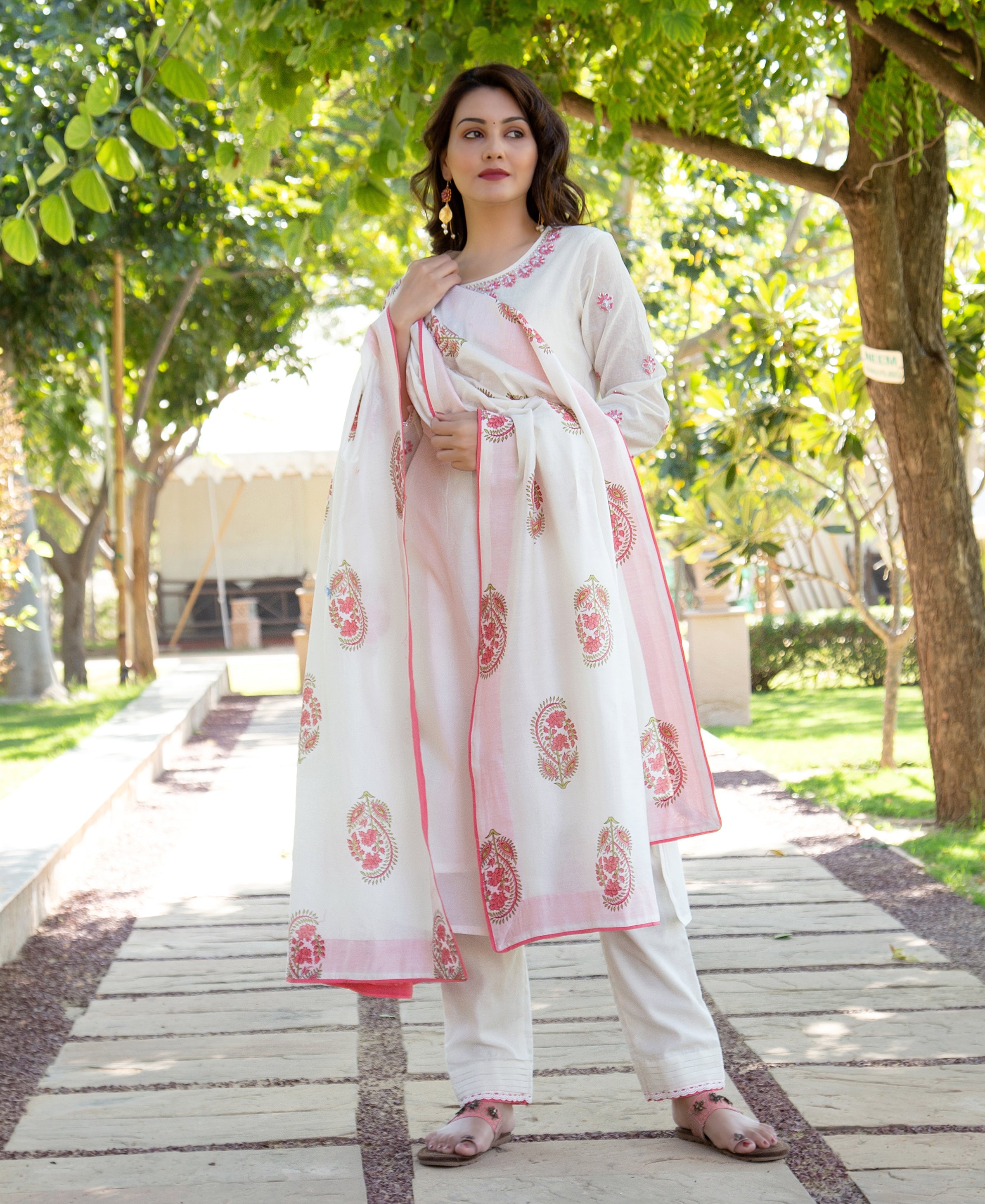 Full-length model in white kurta set with pink embroidered neckline and paisley block-printed dupatta.