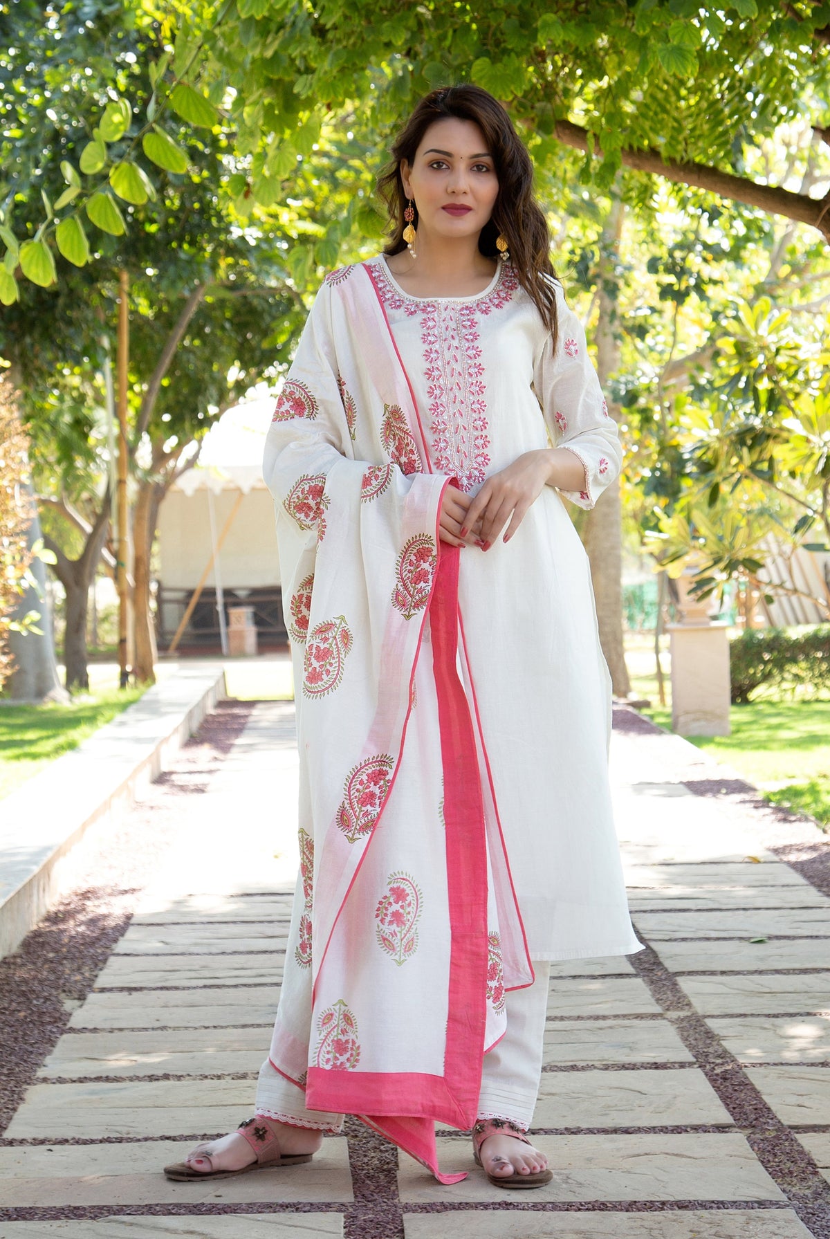 Model in white kurta with pink embroidered neckline and matching floral block-printed dupatta.