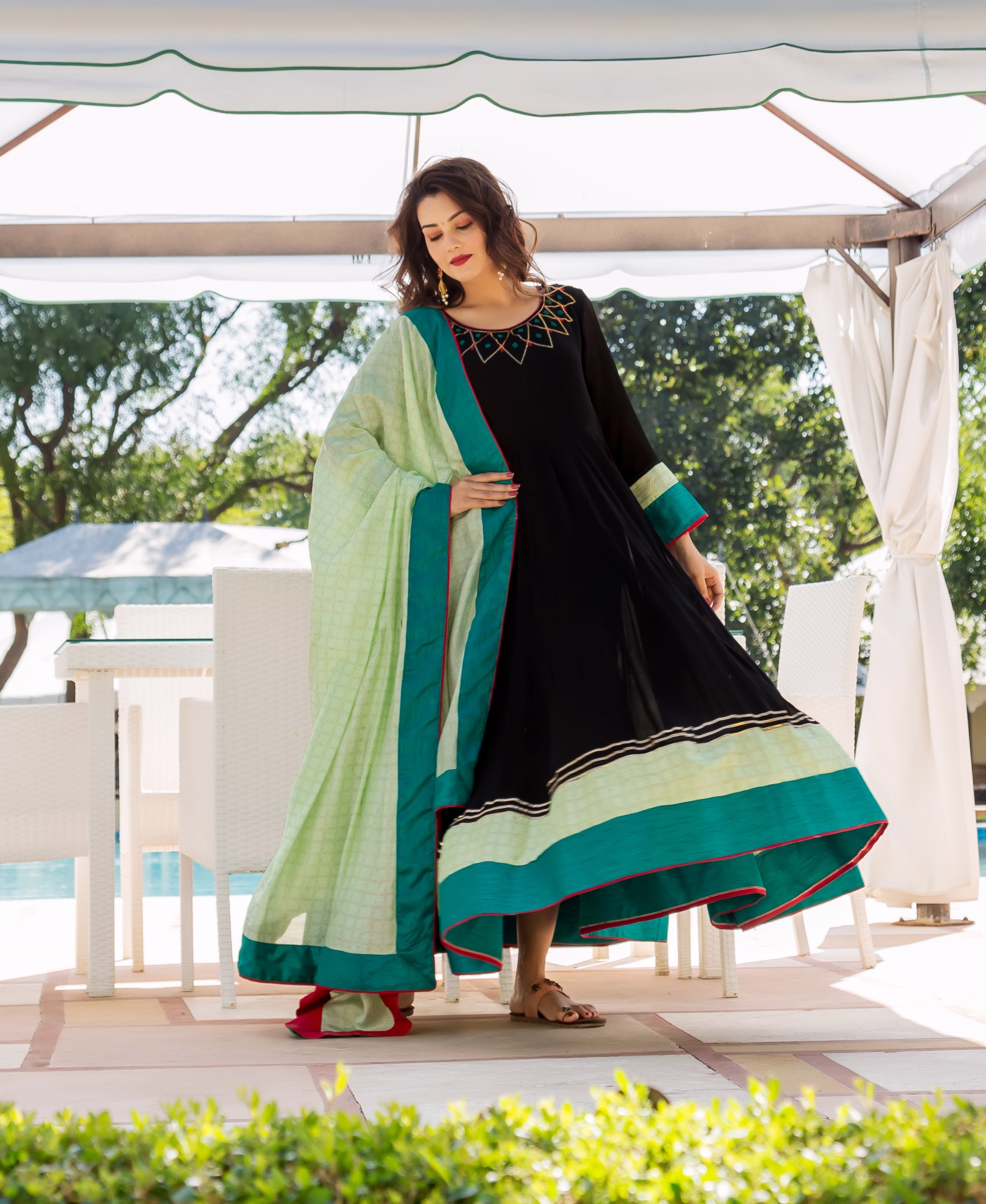 Front view model in black anarkali with patterned lime green dupatta and embroidered yoke.