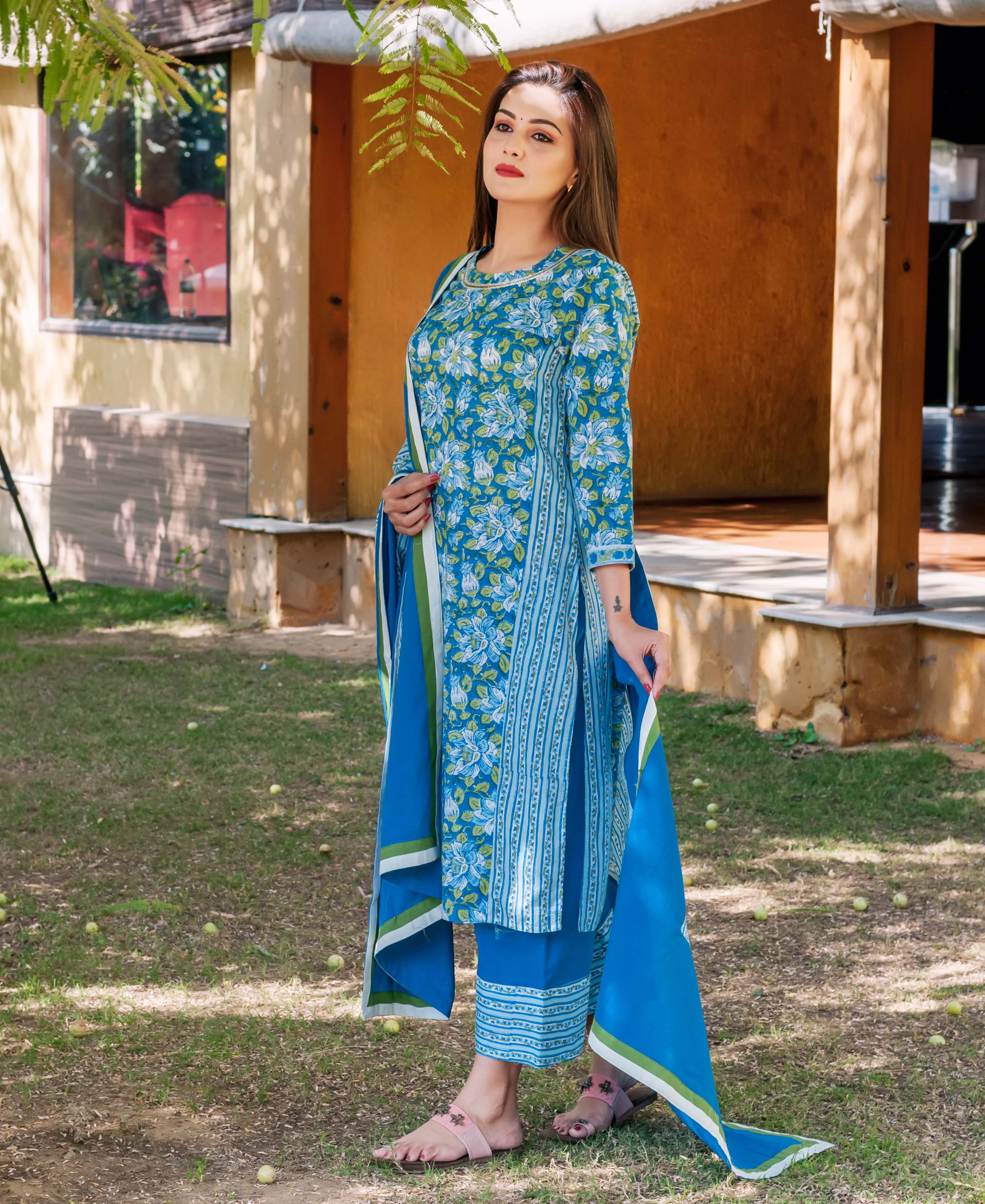 Full-length model in a sapphire blue hand block printed floral and striped kurta set.