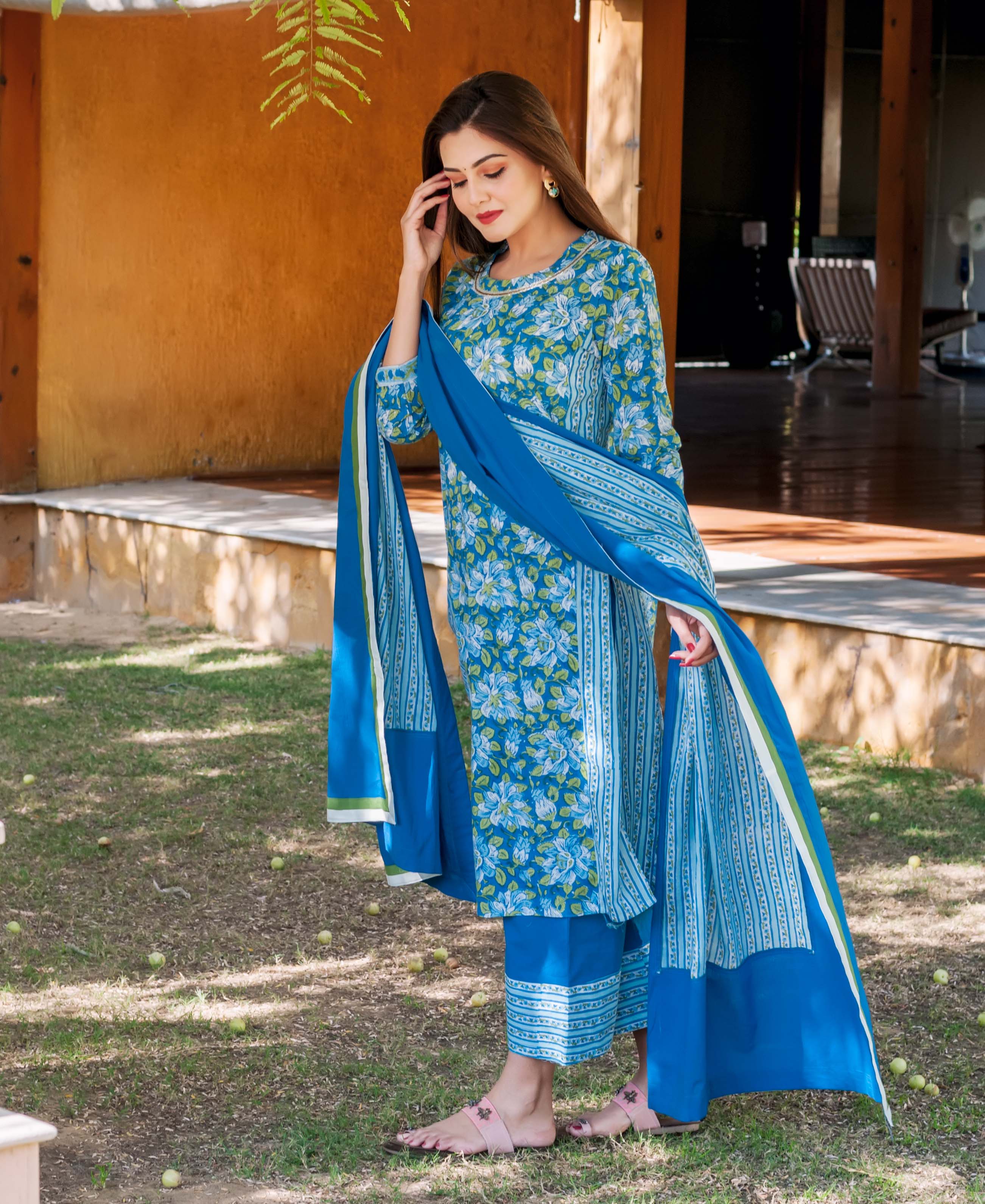 Woman models a blue floral hand-block printed ethnic kurta set in a full-length shot.