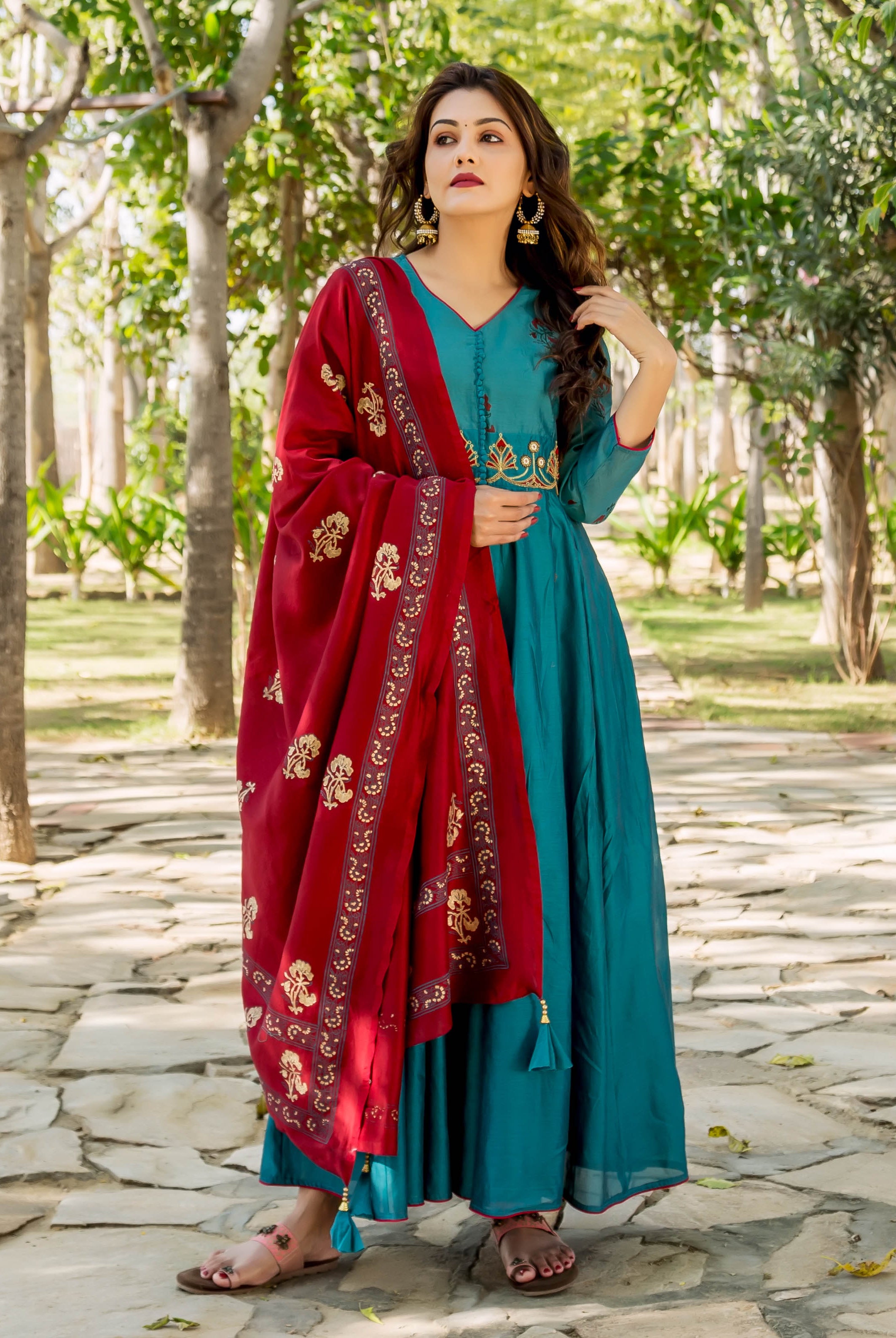 Front view of model in full-length teal embroidered kurta with vibrant red block-printed dupatta.
