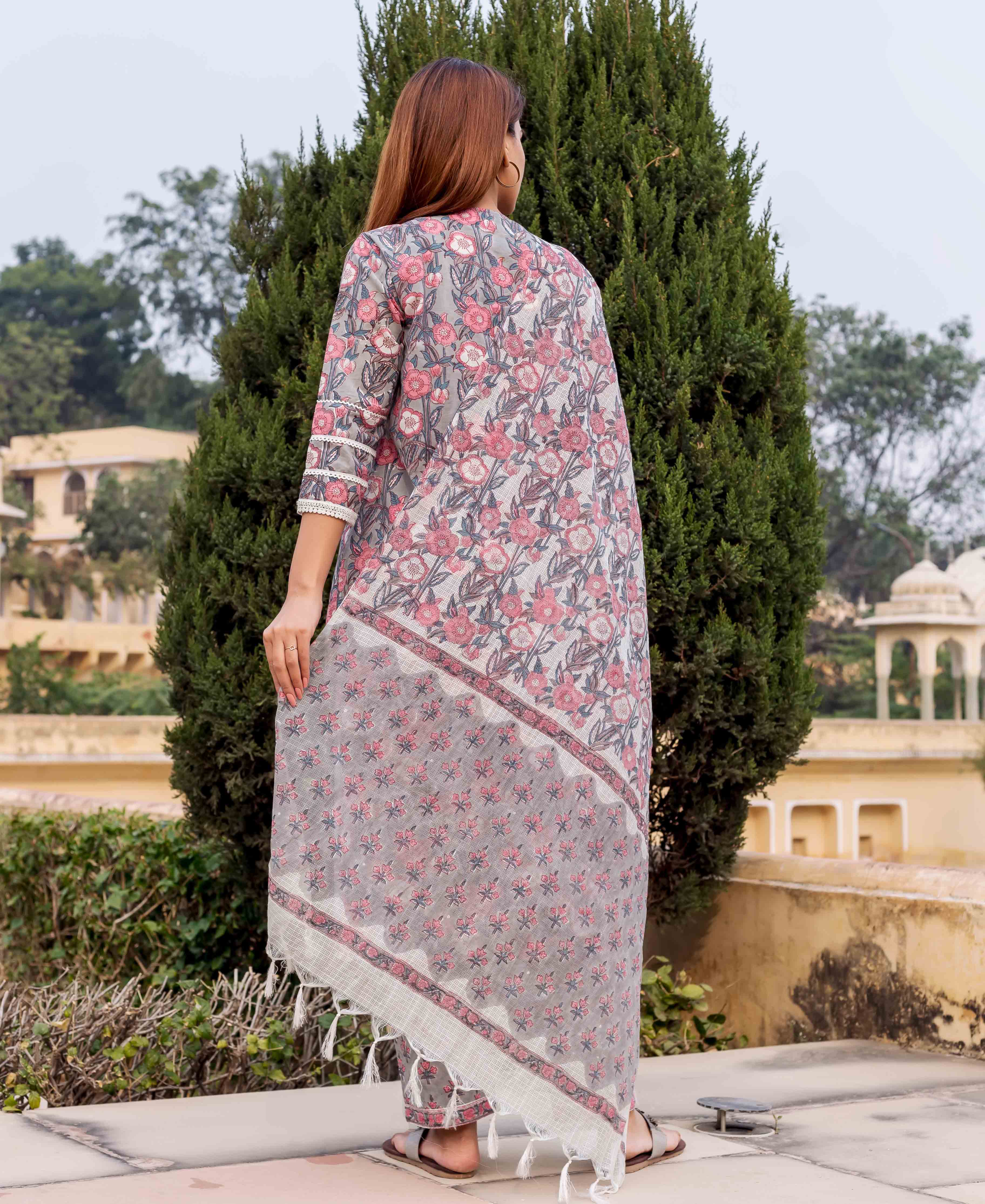 Back view of model in grey and pink hand block printed floral kurta and dupatta.