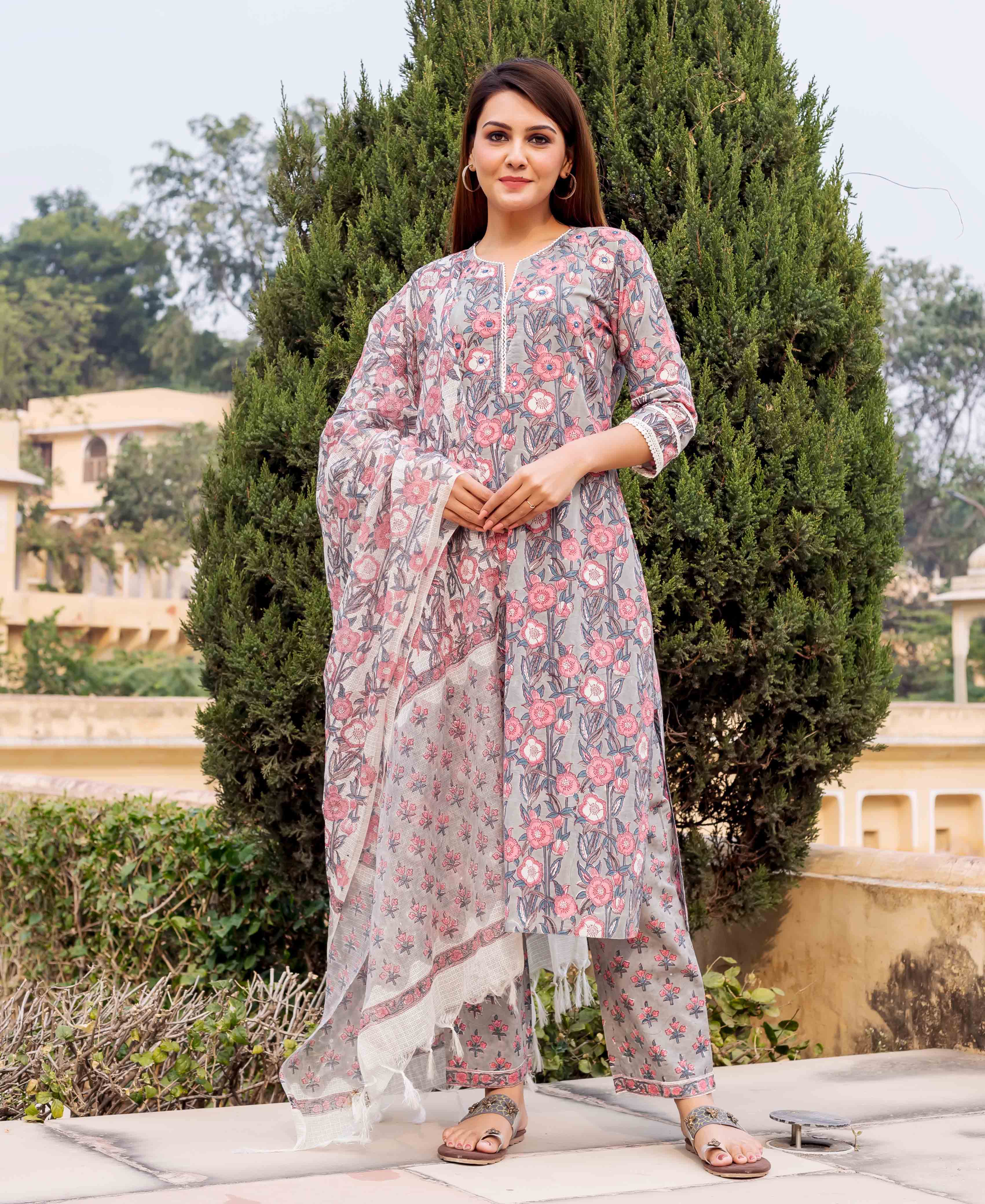 Front view of model in grey and pink floral hand block printed kurta set.
