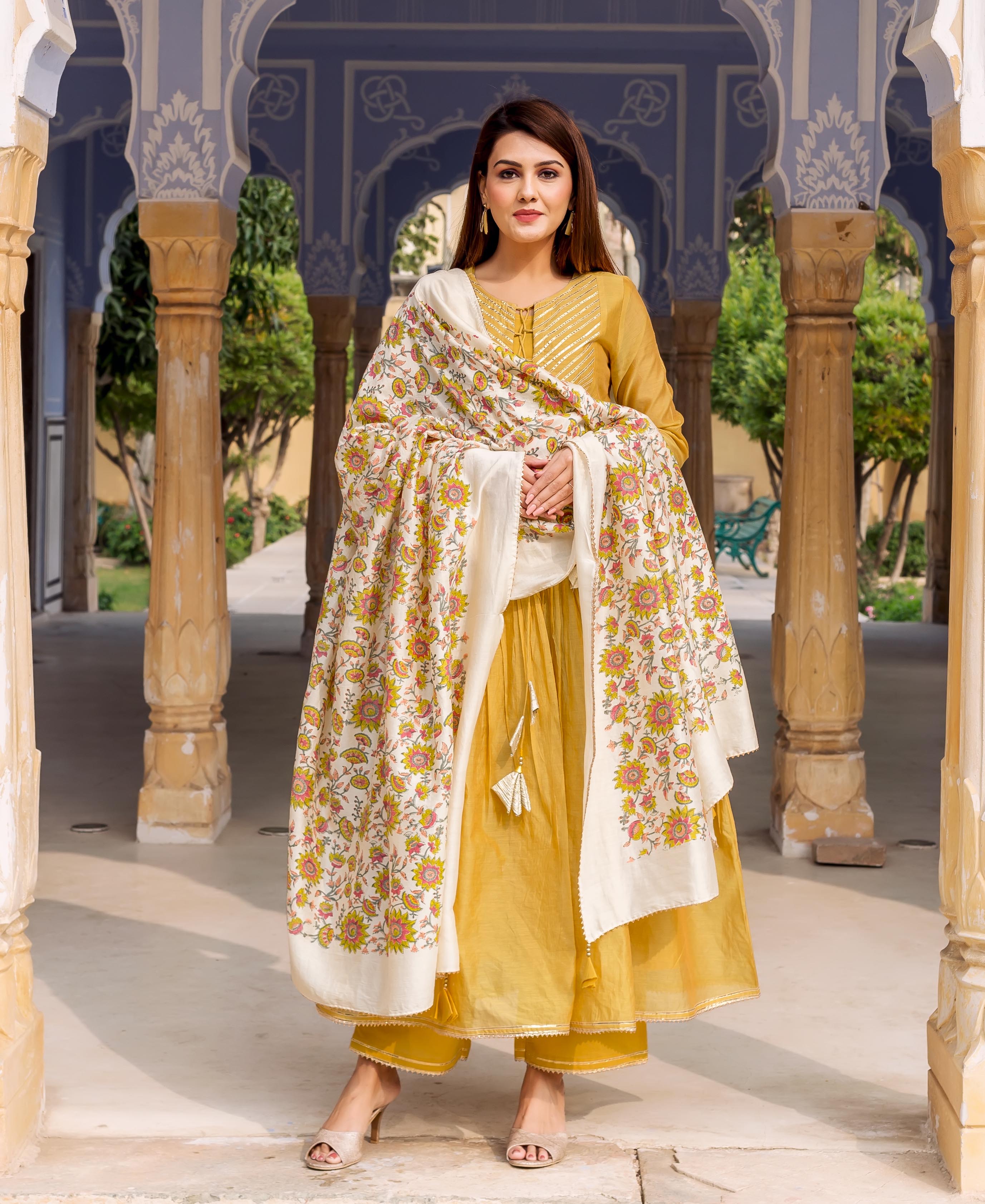 Model in honey yellow gotta work kurta, palazzos, and floral block-printed dupatta.