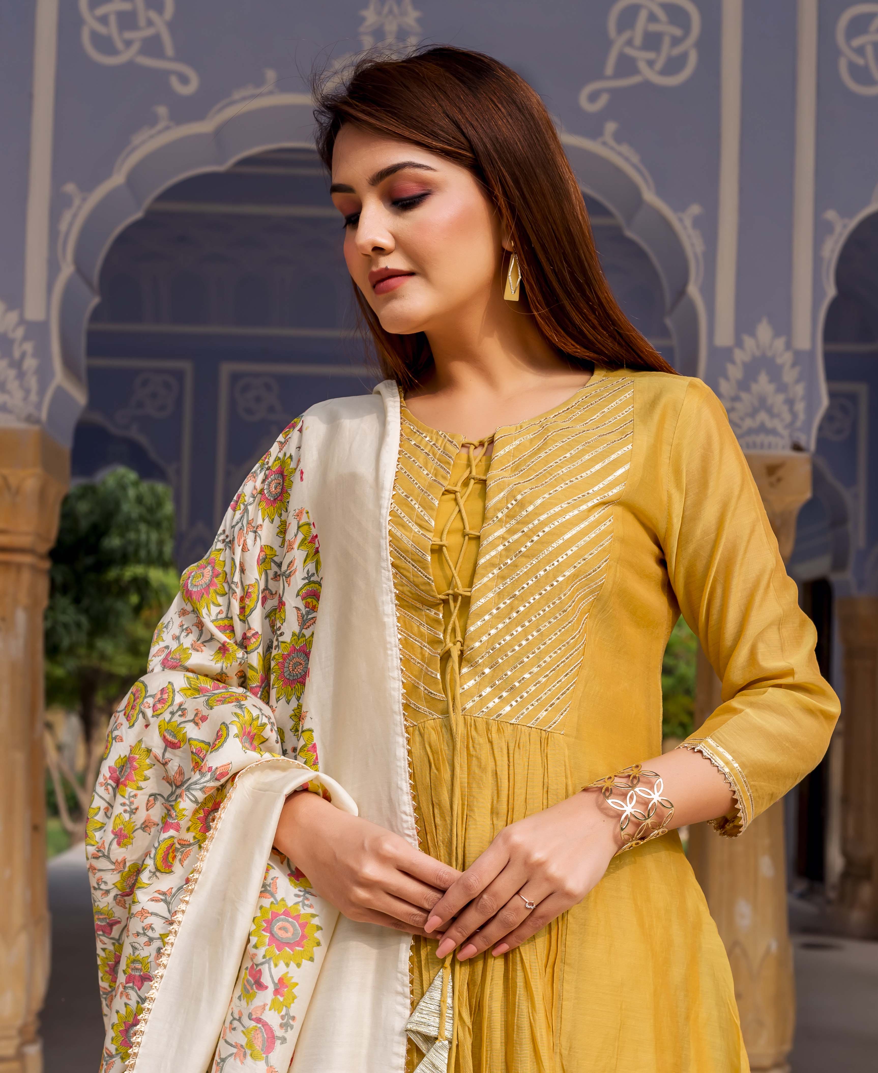 Front view of model in honey yellow gotta work kurta with floral hand-block printed dupatta.