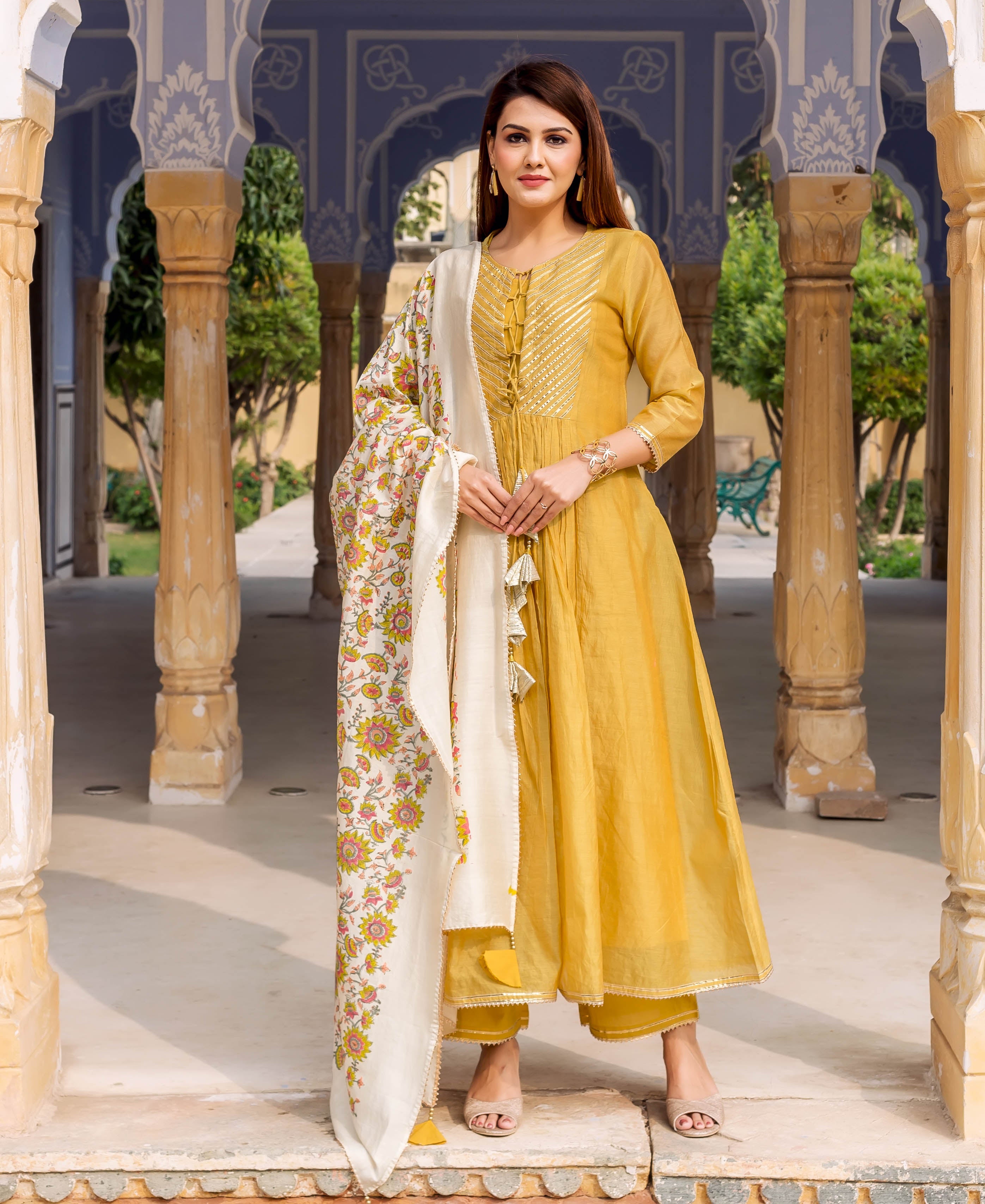 Model wearing honey yellow kurta with gotta work and floral block-printed dupatta, full front view.