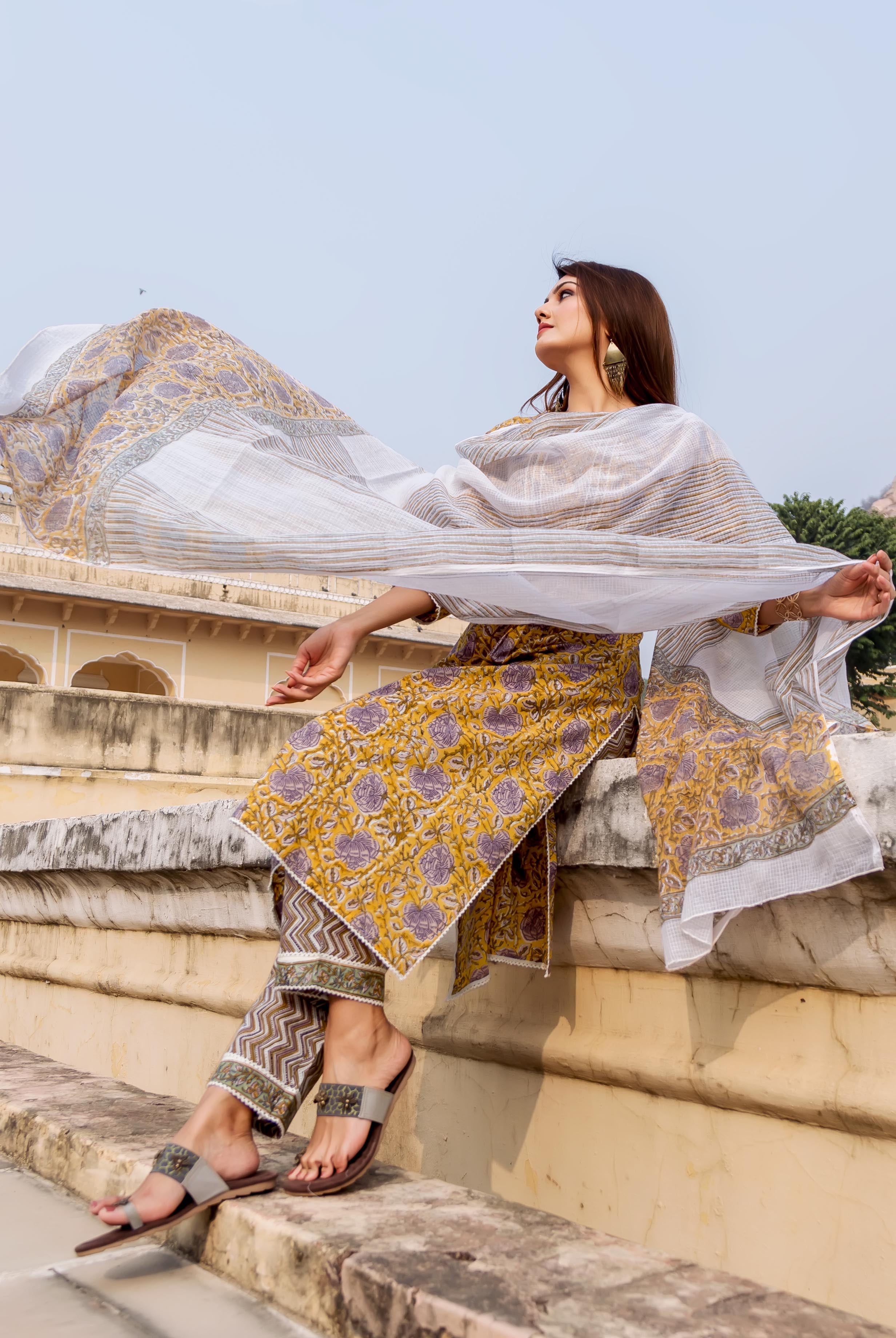 Full look: Model in yellow and grey hand-block printed ethnic kurta set with flowing white dupatta.