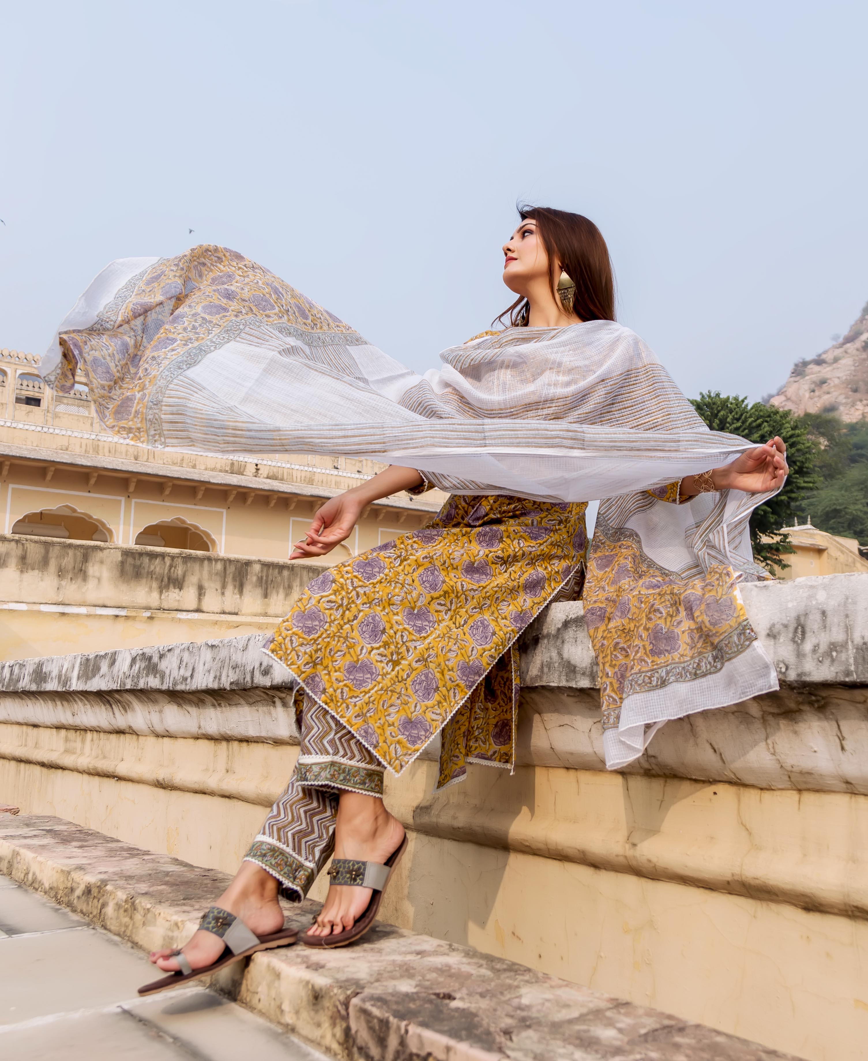 Full look: Model in yellow and grey hand-block printed ethnic kurta set with flowing white dupatta.