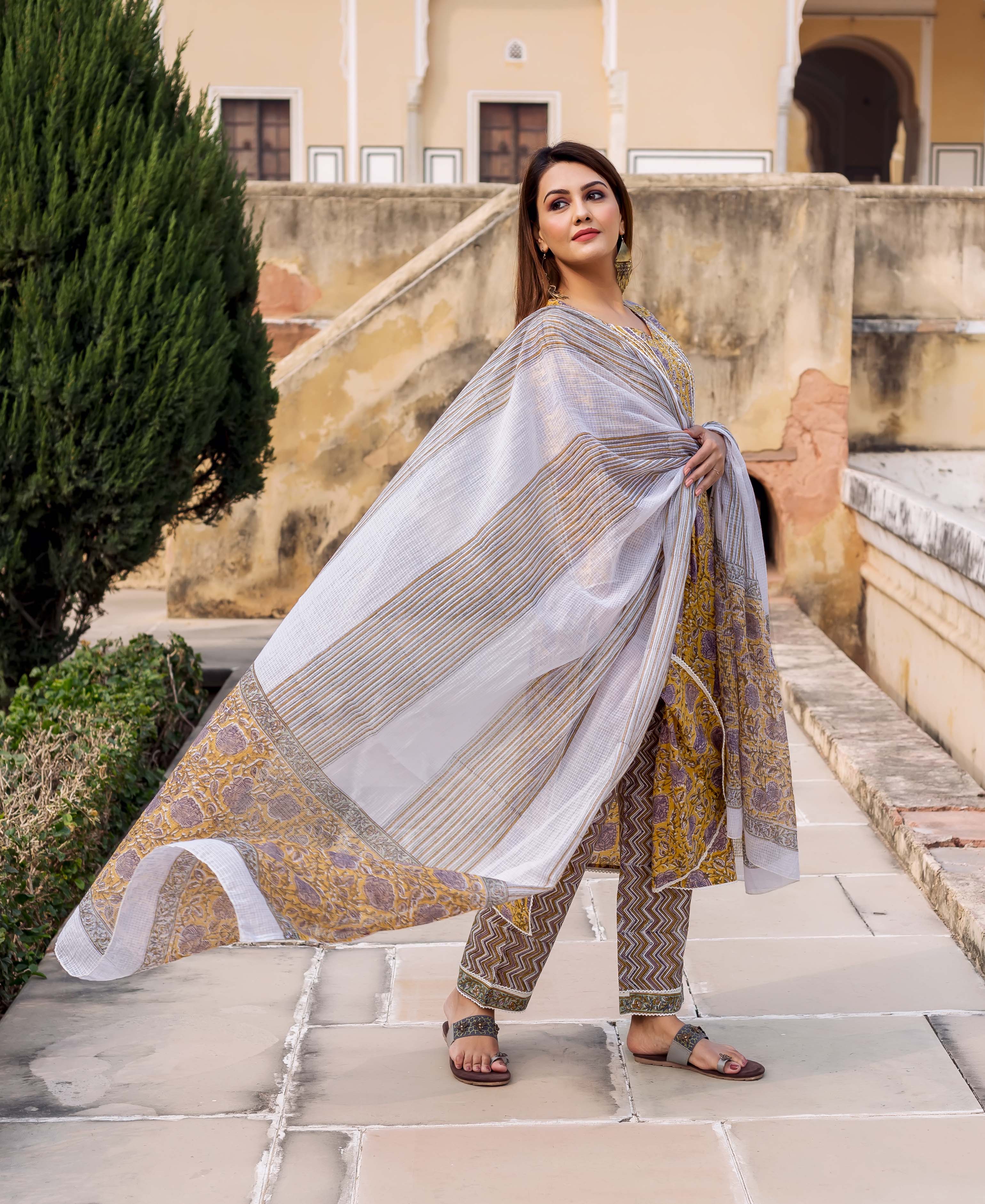 Yellow and grey hand block printed straight kurta set on model with flowing dupatta.