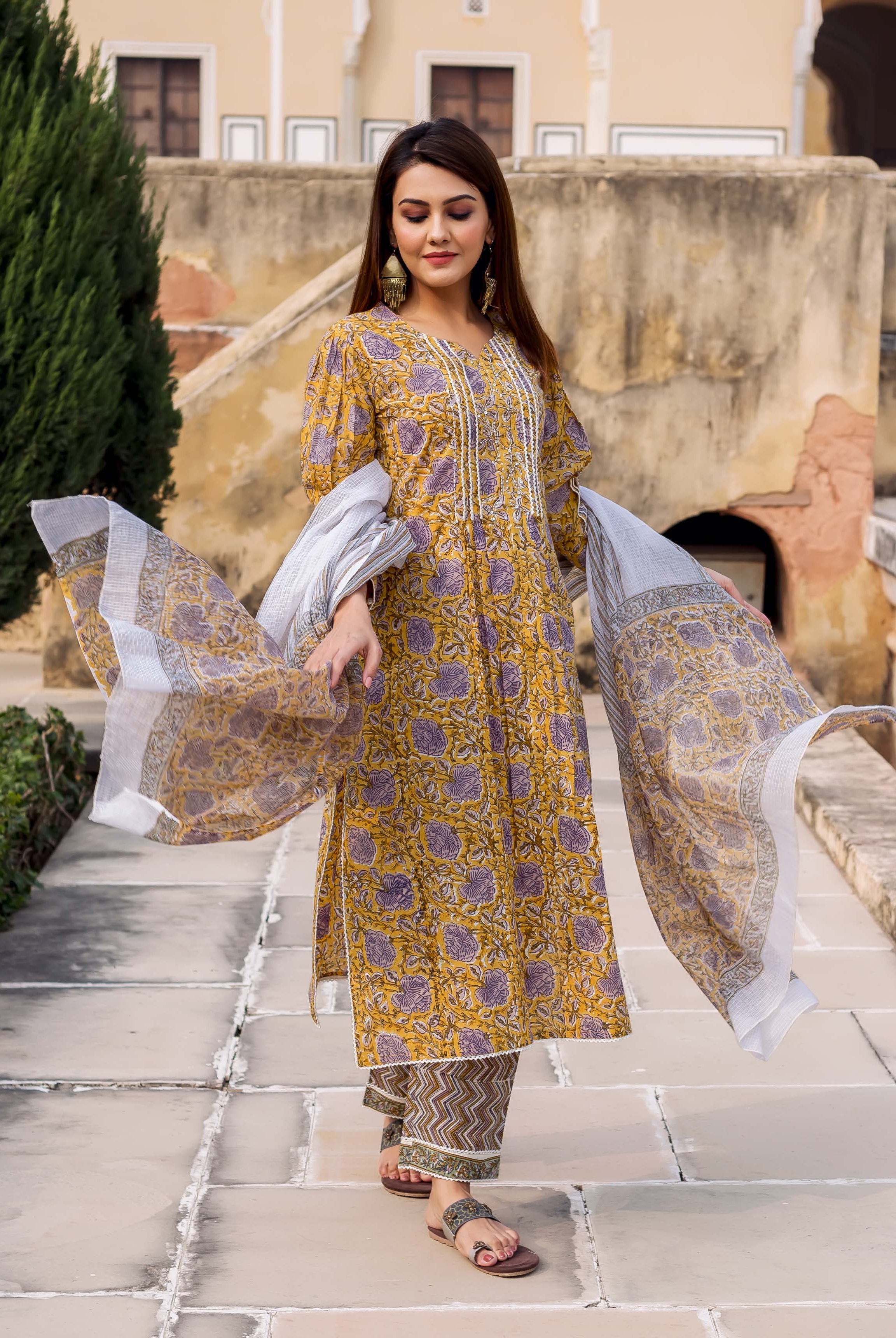 Model wearing yellow and grey hand block printed kurta set, full look with dupatta.