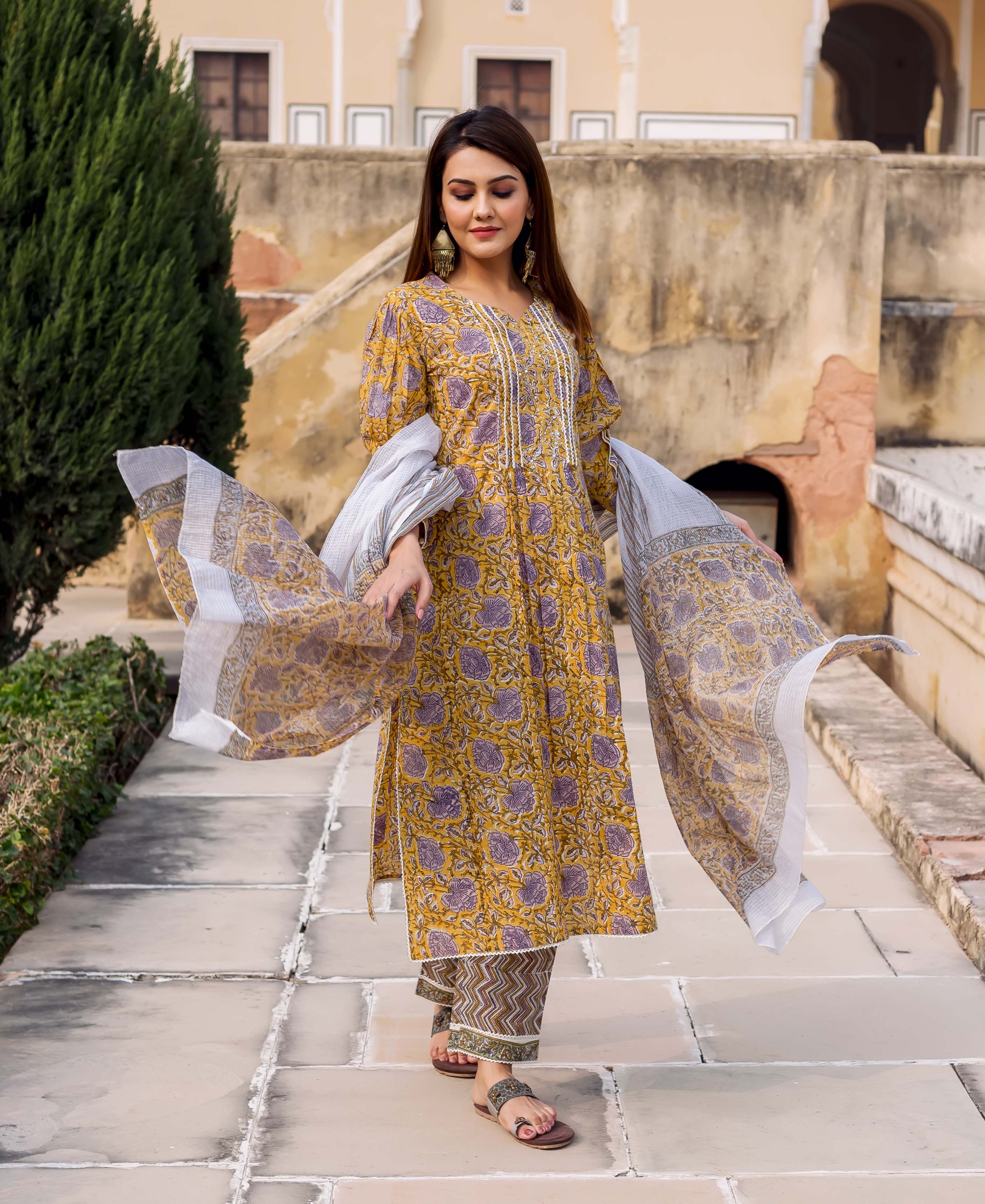 Model wearing yellow and grey hand block printed kurta set, full look with dupatta.