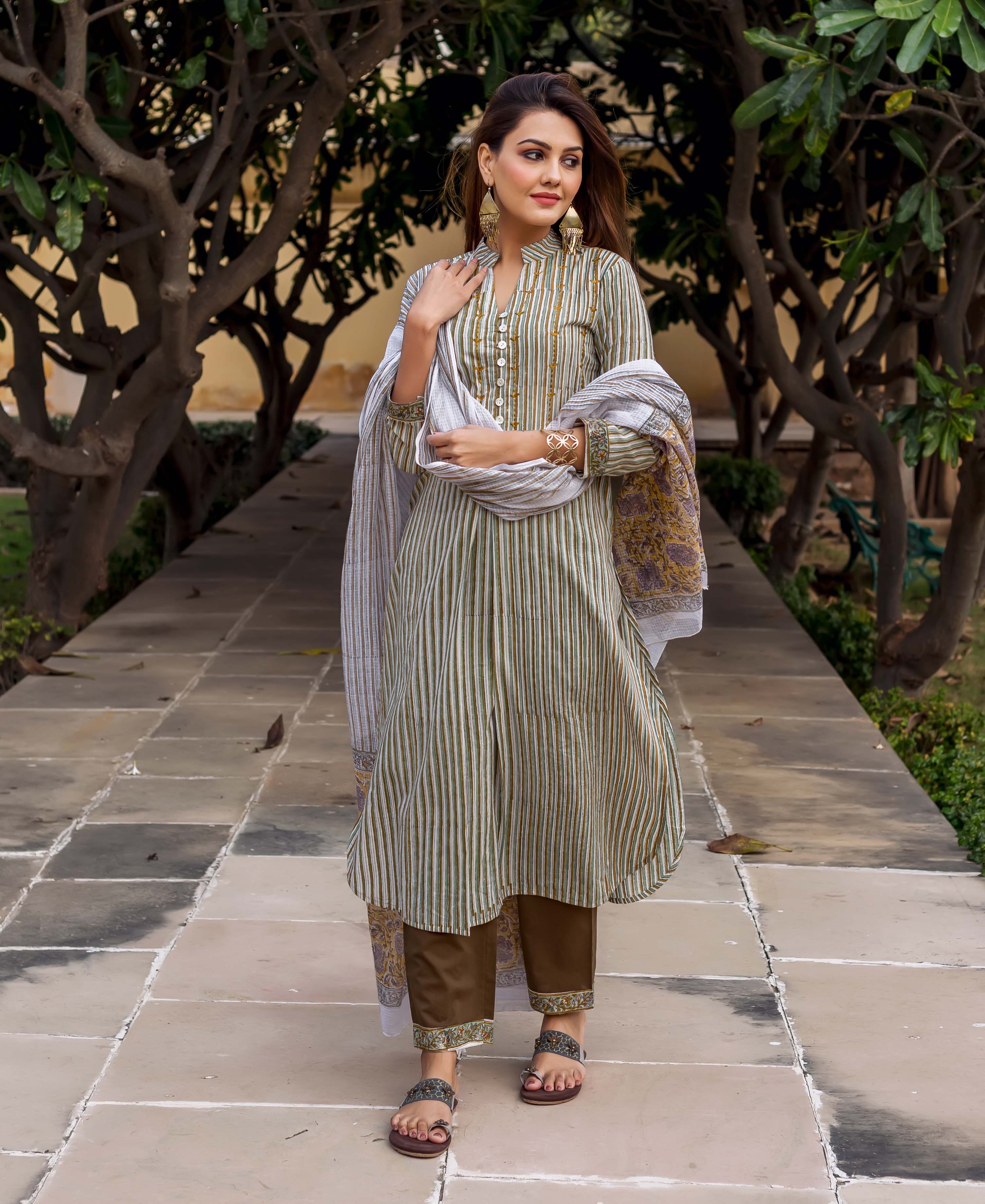 Woman in olive green striped, printed, and embroidered kurta with brown pants and dupatta.