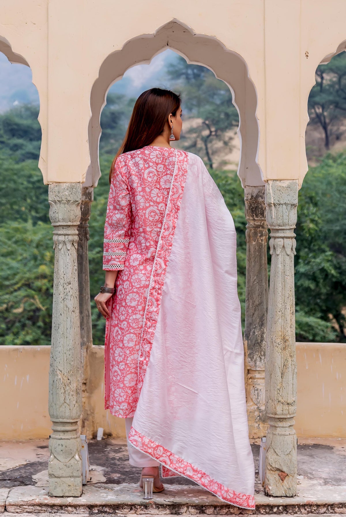 Back view model in peach and white hand block printed kurta set with dupatta.
