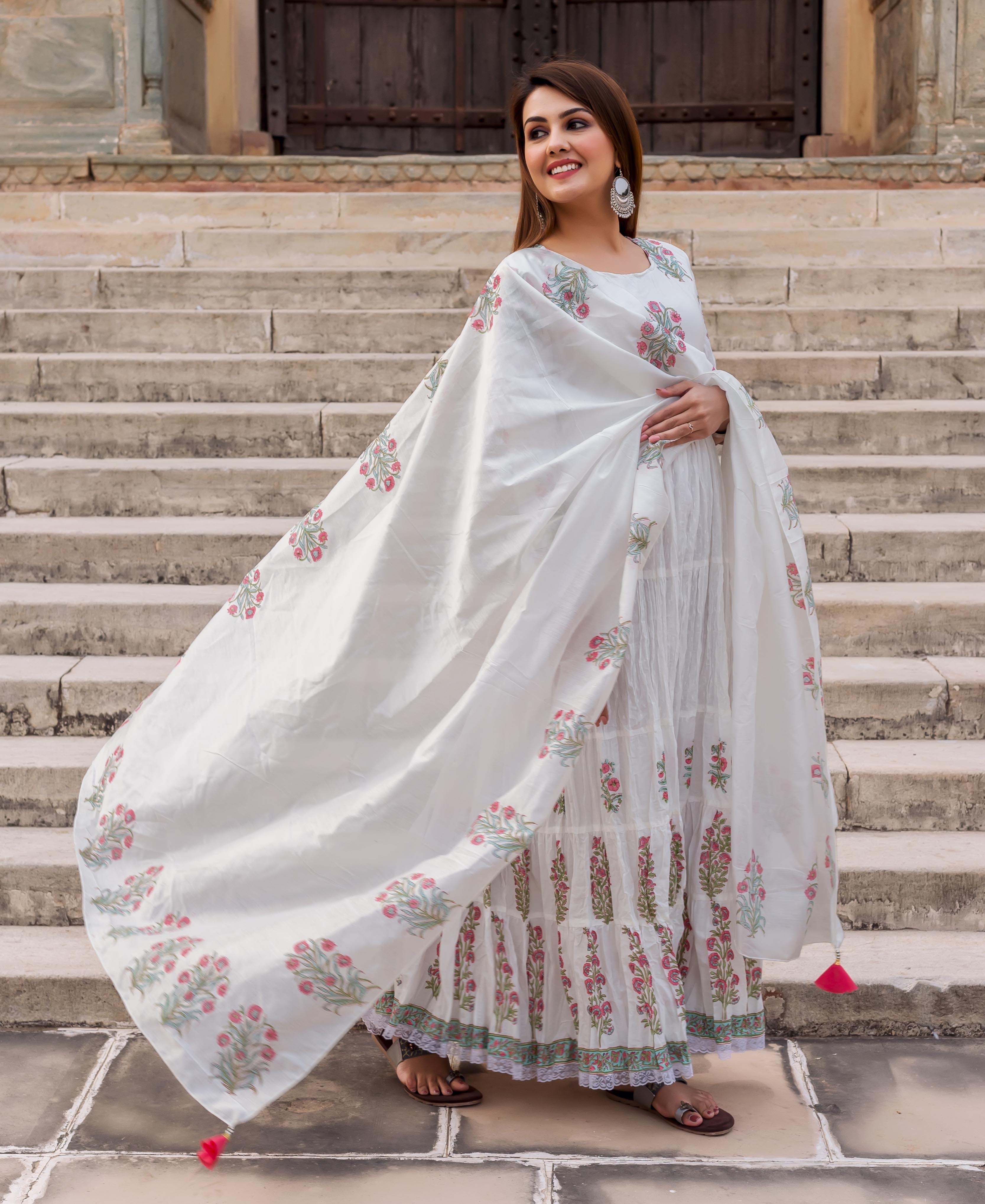 Full-length front view of model in white butta print tiered dress and flowing dupatta.