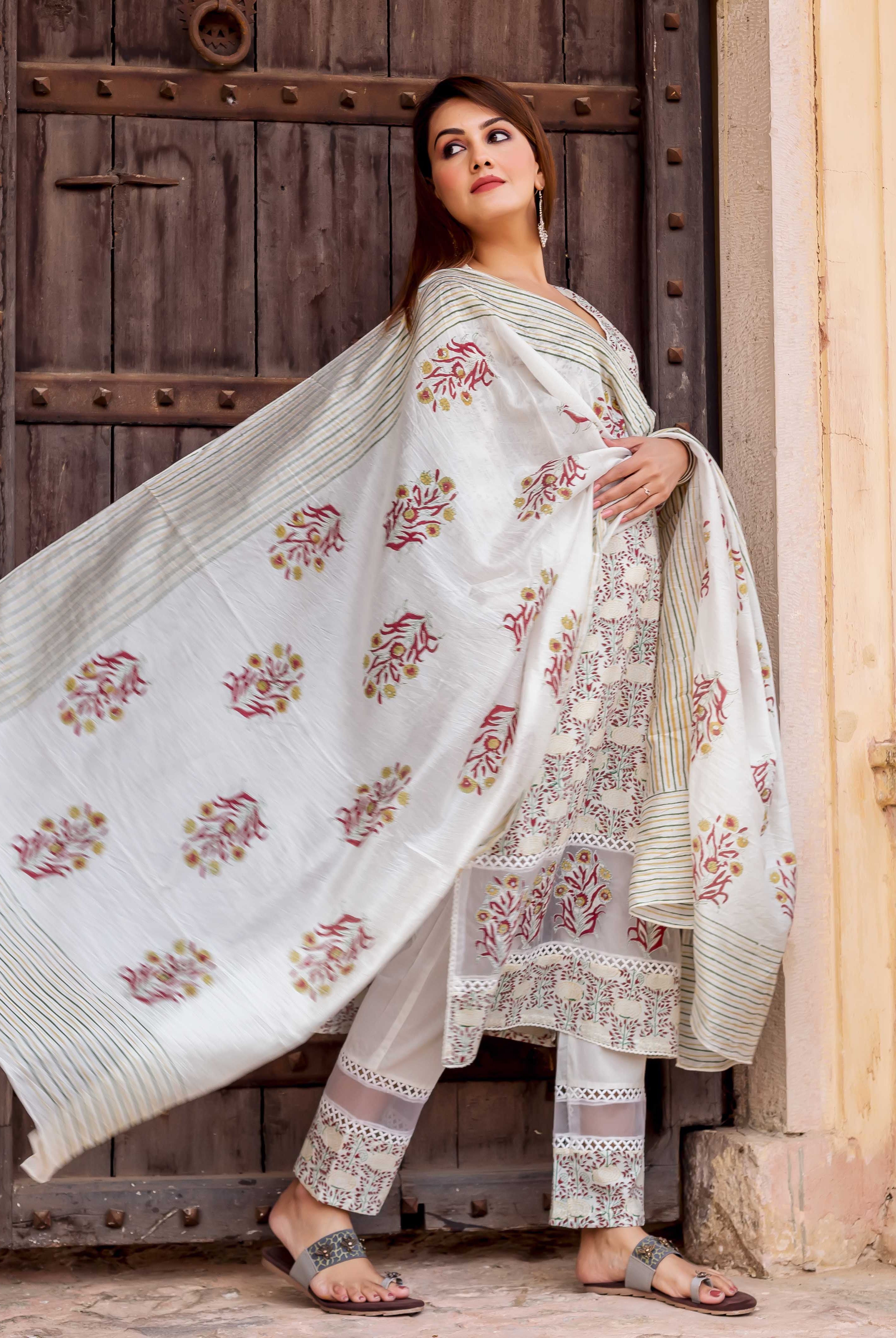 Model in off-white block-printed kurta set with red and yellow floral patterns, striped dupatta.