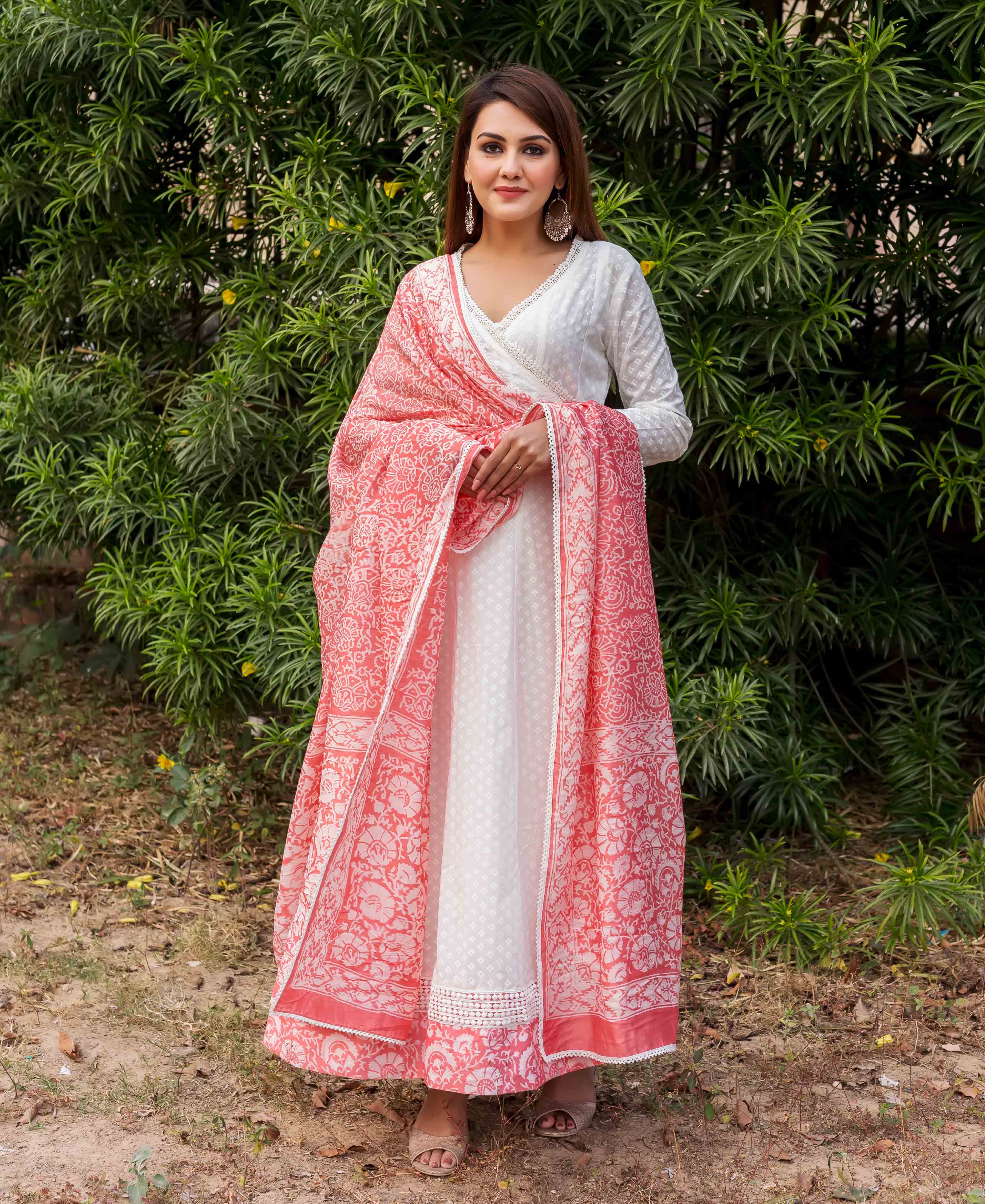Model in a white angrakha dress with a peach hand-block-printed dupatta.