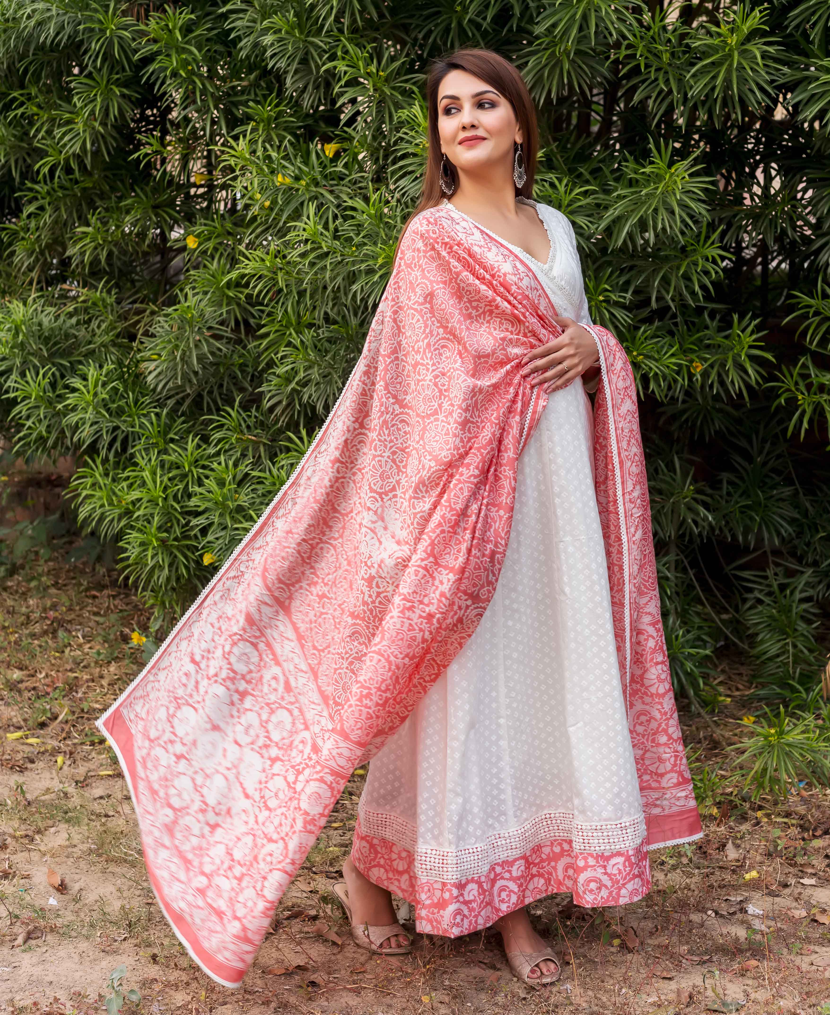 Full-length view of model in white Angrakha dress with peach hand-block-printed ethnic dupatta.