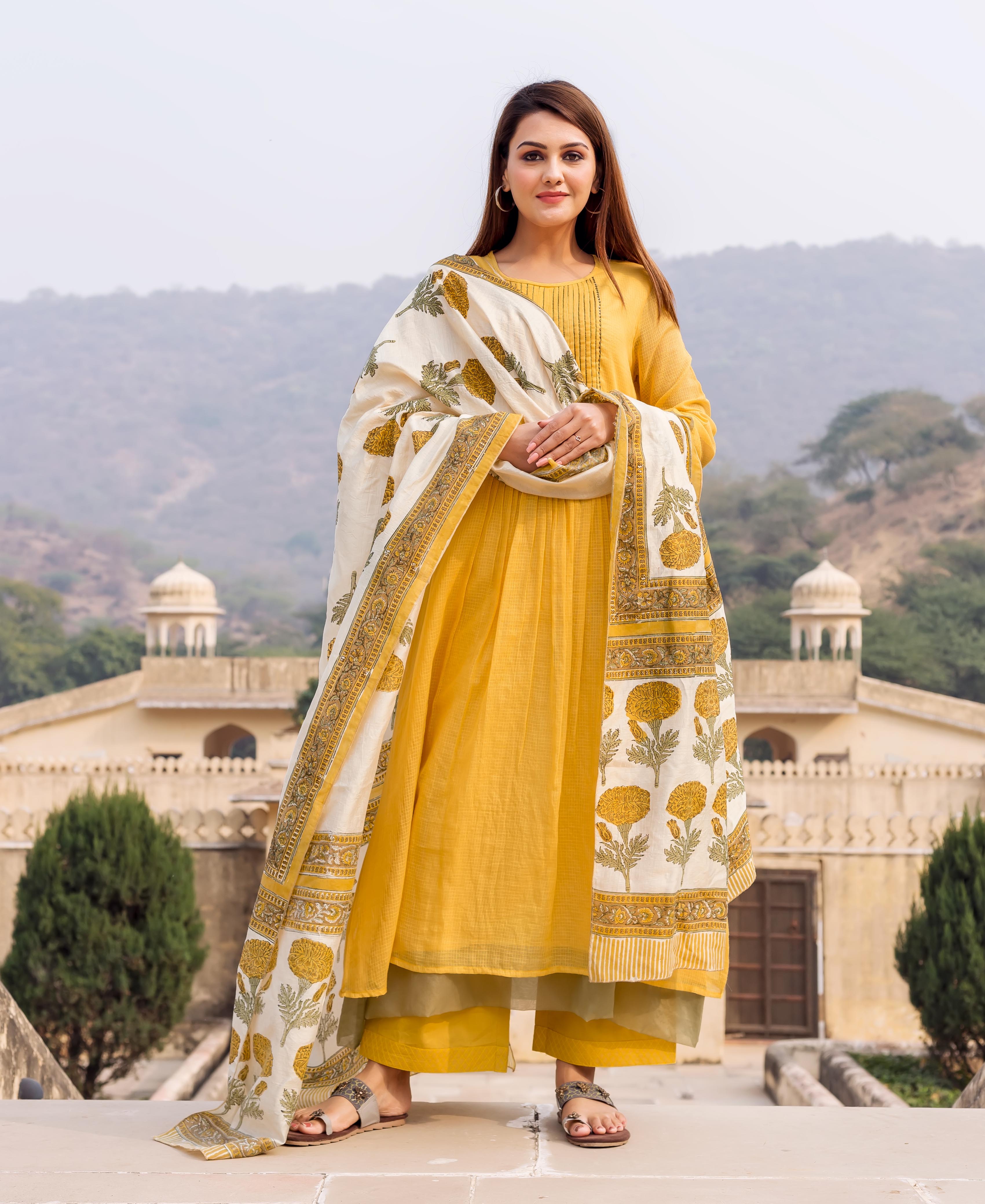 Model wearing honey yellow embroidered kurta, olive palazzo, and cream floral block print dupatta.