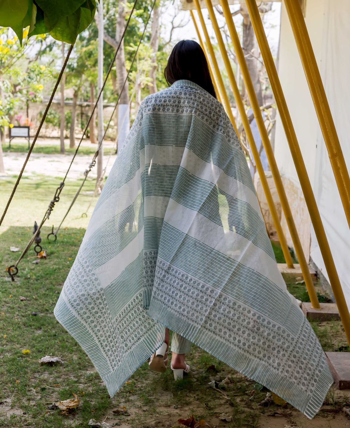A model wearing a white and blue hand-block-printed kurta with a geometric pattern.