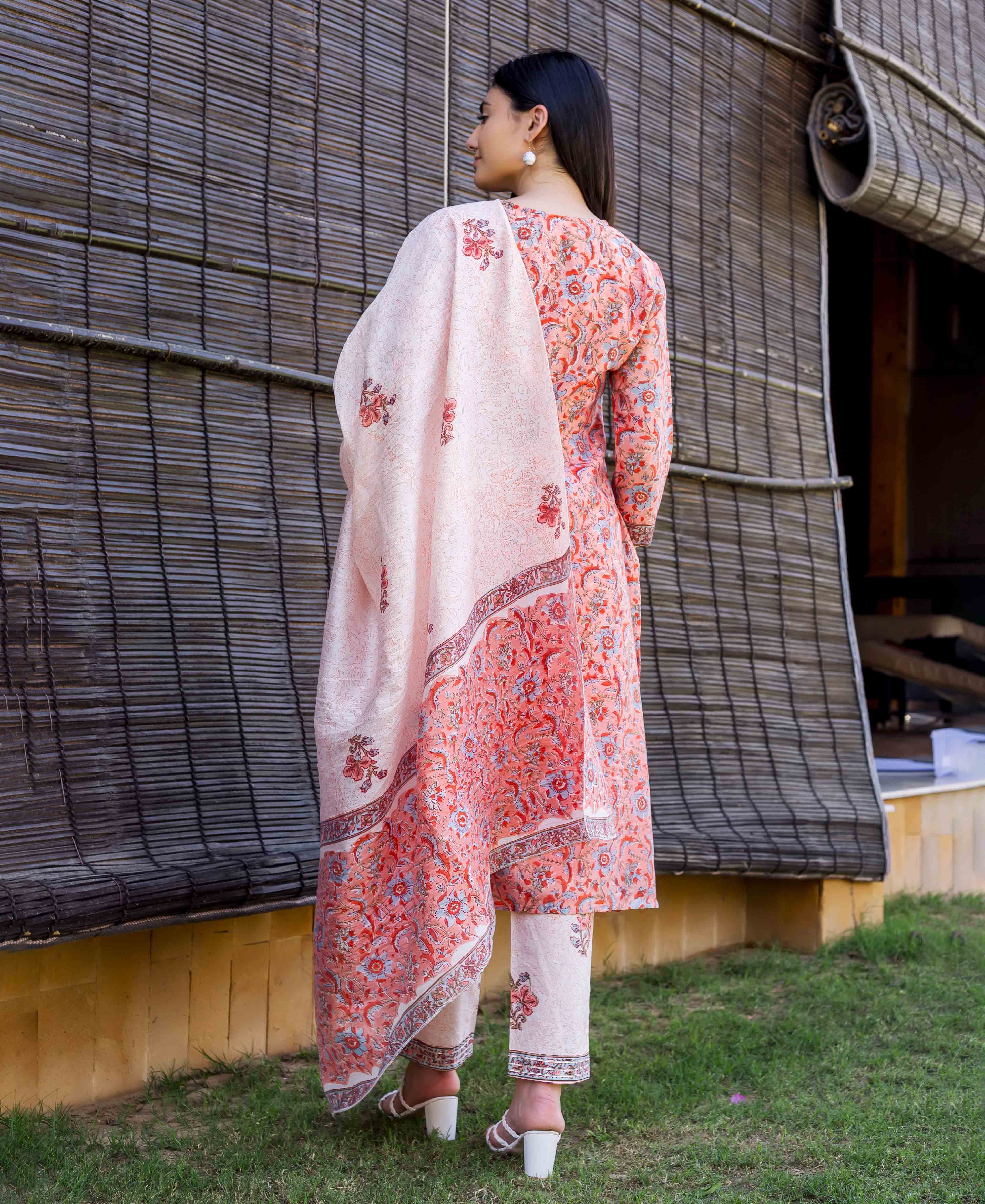 Model from back in peach block-printed straight kurta set with intricate floral design.