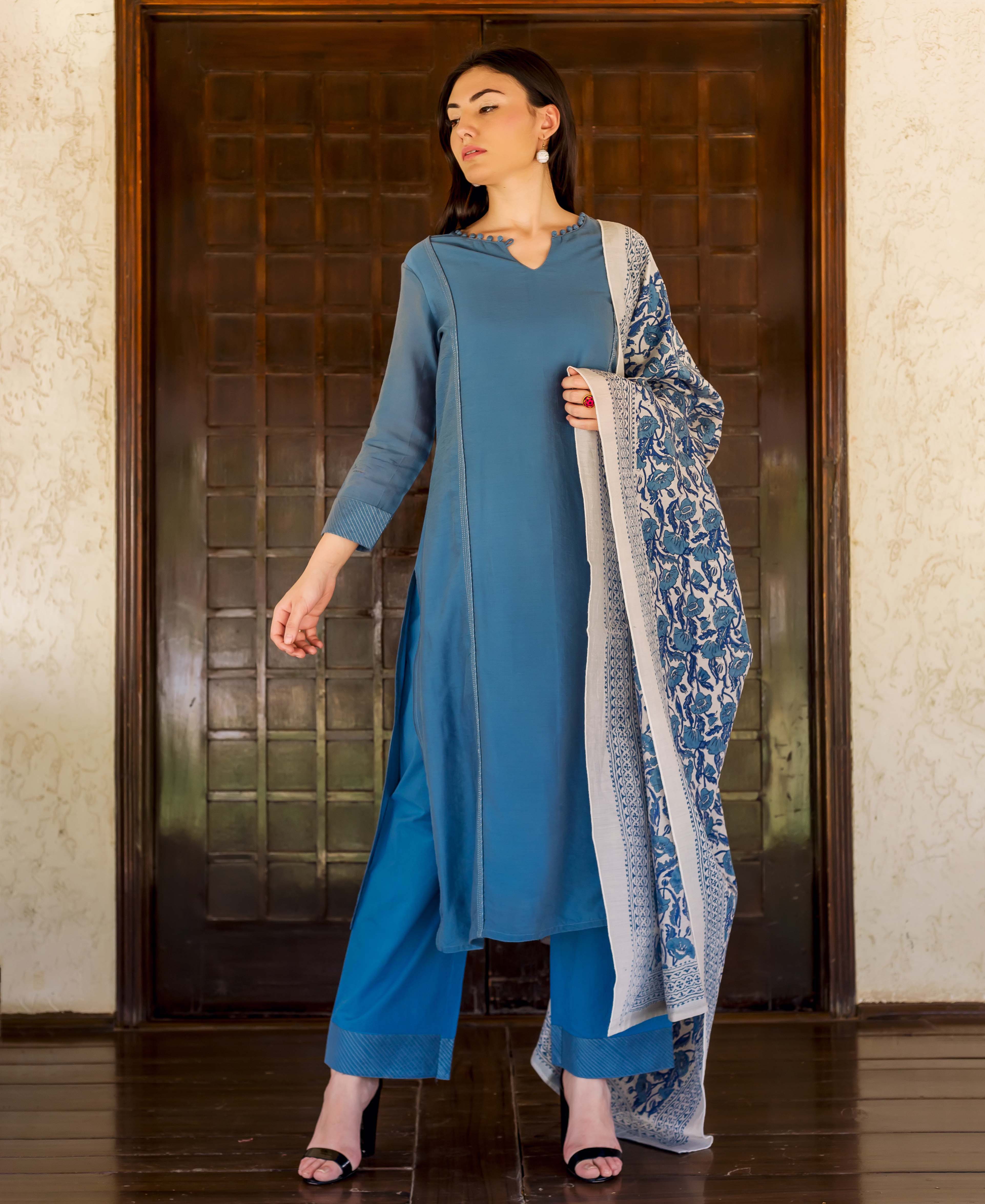 Full shot model in Prussian blue embroidered kurta, palazzo, and floral block-printed dupatta.