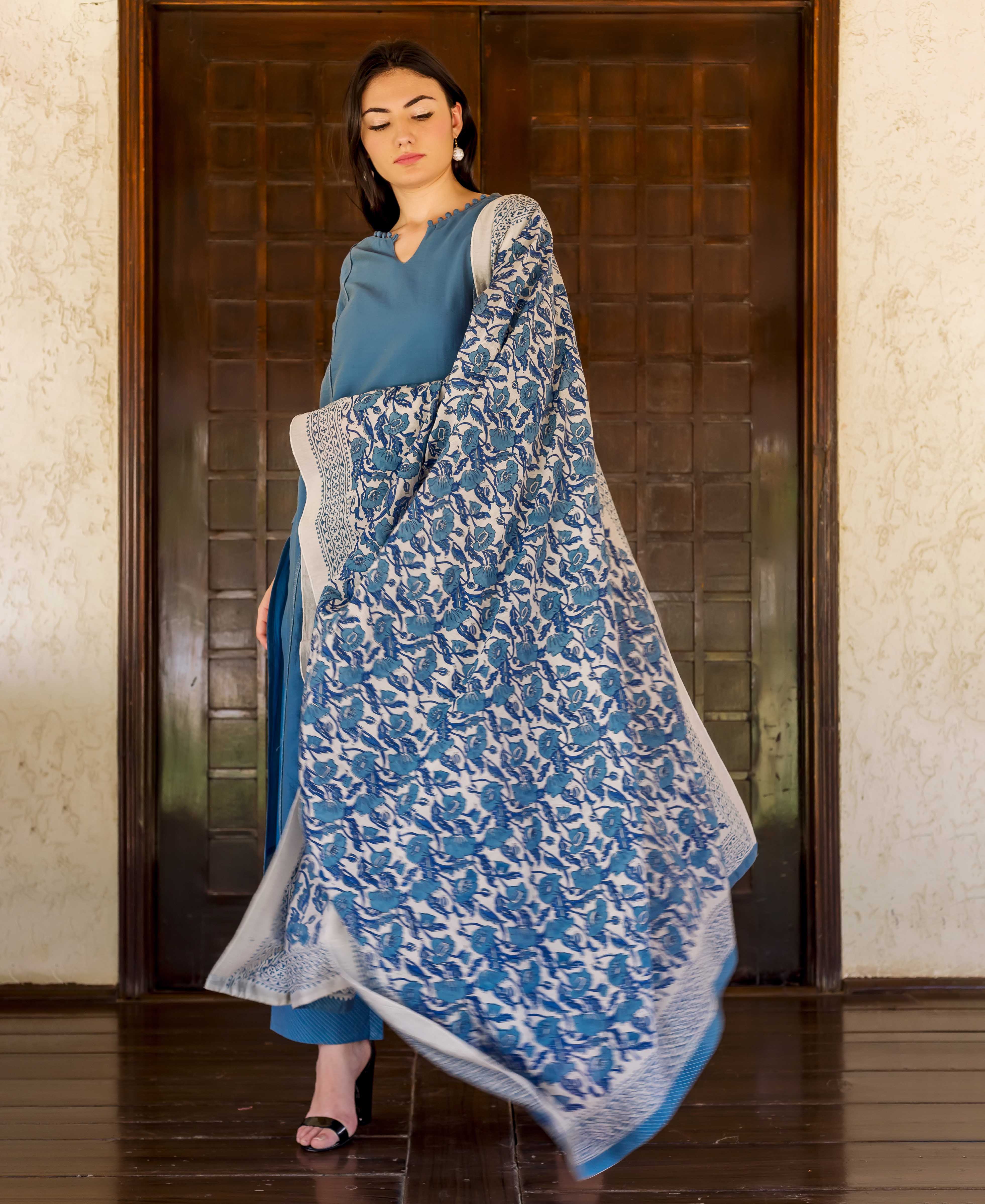 Model in Prussian blue kurta with scalloped neck and white-blue hand-block-printed ethnic dupatta.