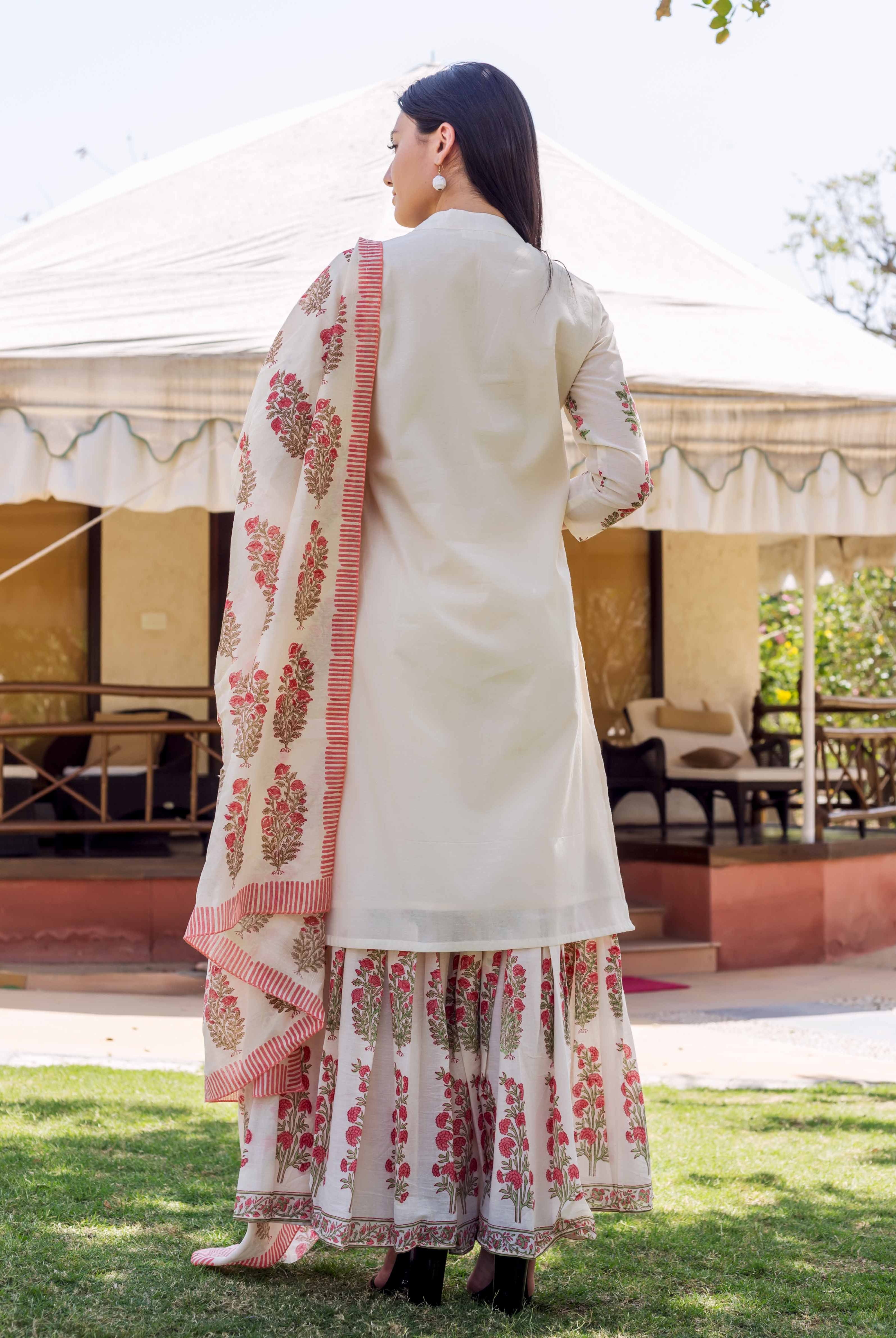 A model wearing an ivory kurta with red floral block print and embroidery.
