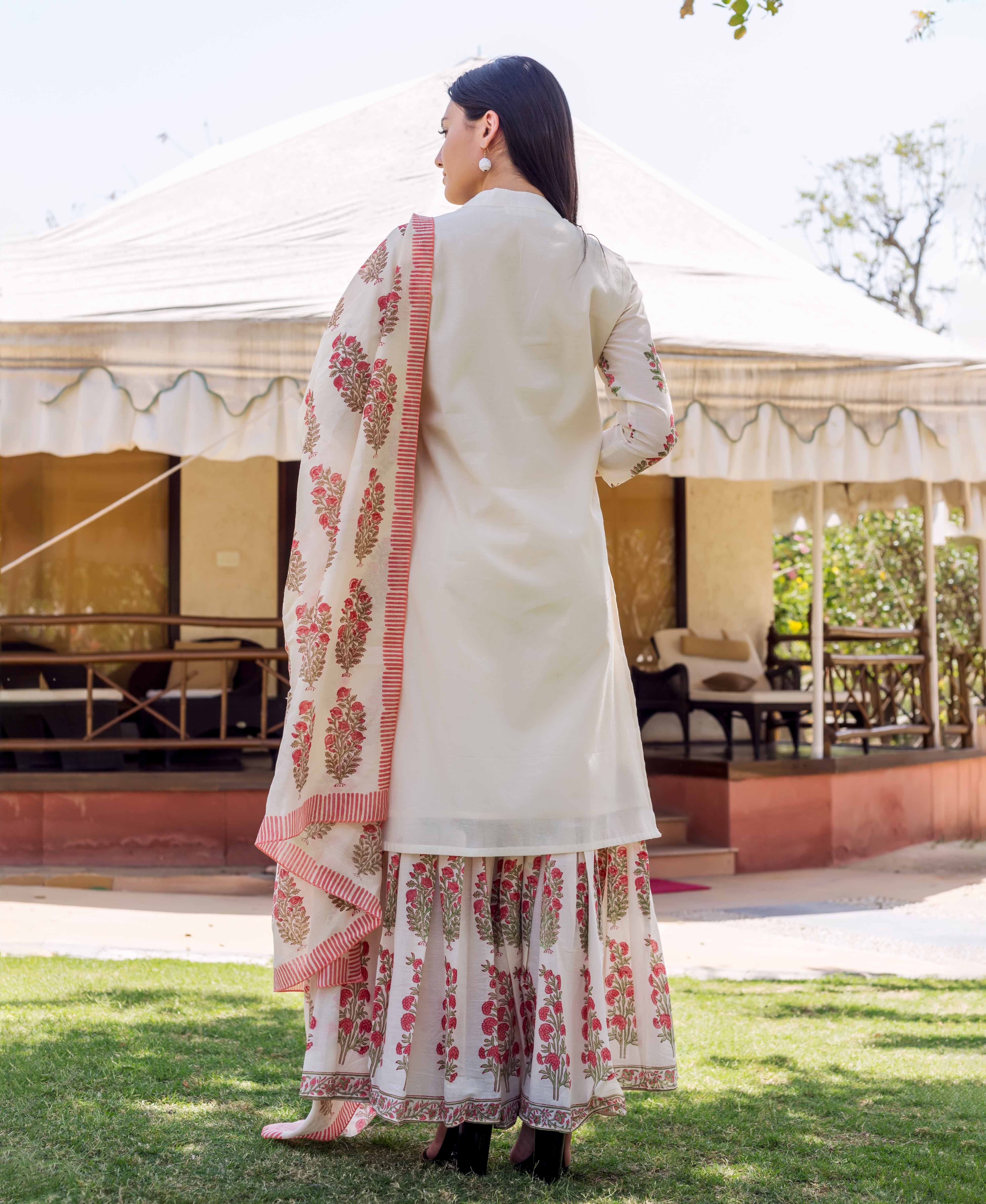 A model wearing an ivory kurta with red floral block print and embroidery.