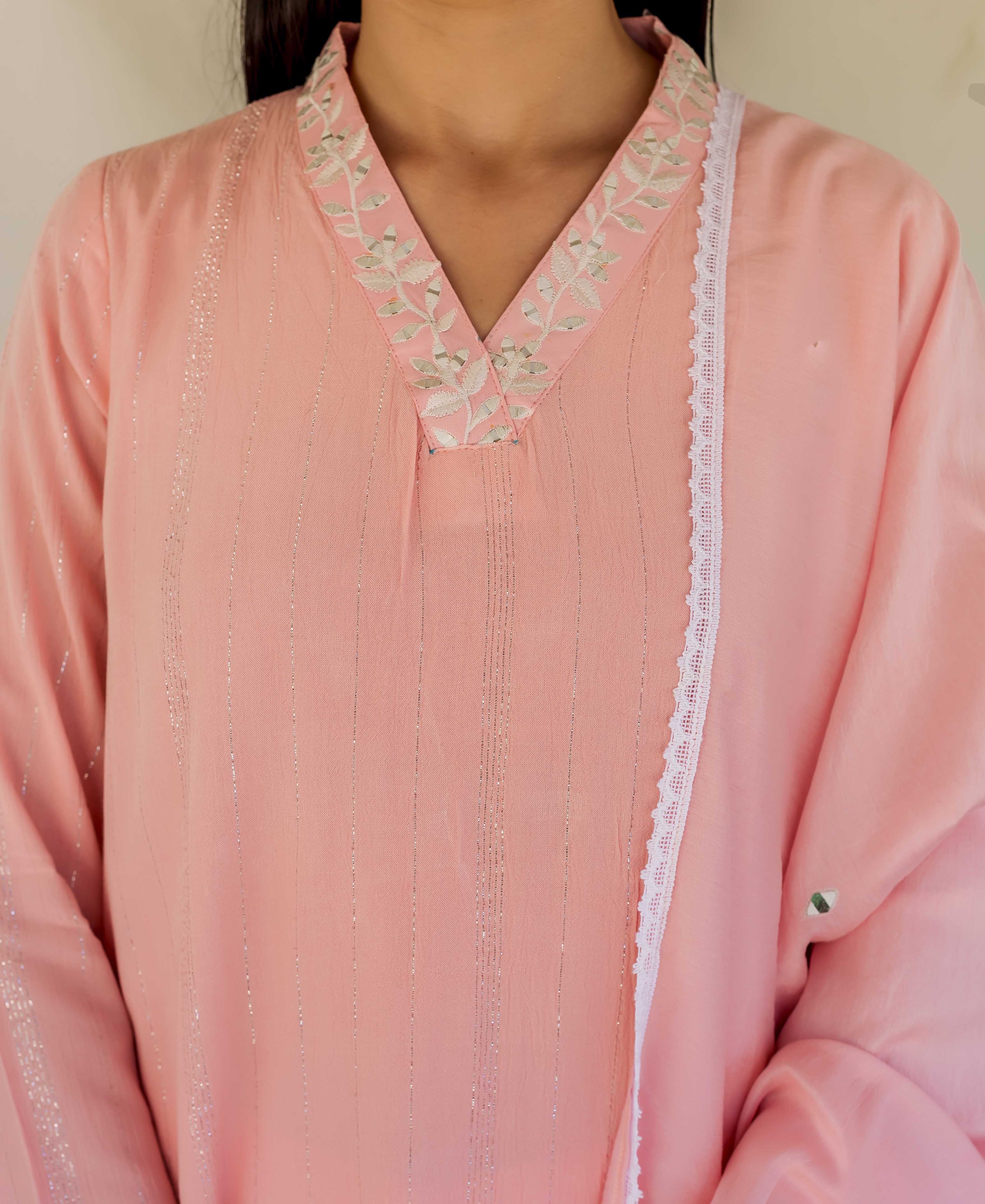 Pink straight kurta on model, featuring an embroidered V-neckline and shimmering vertical silver stripes.