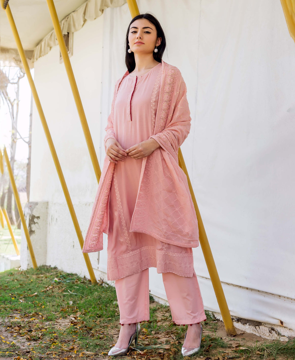 Model in a dusty pink embroidered straight kurta and matching pants with dupatta.