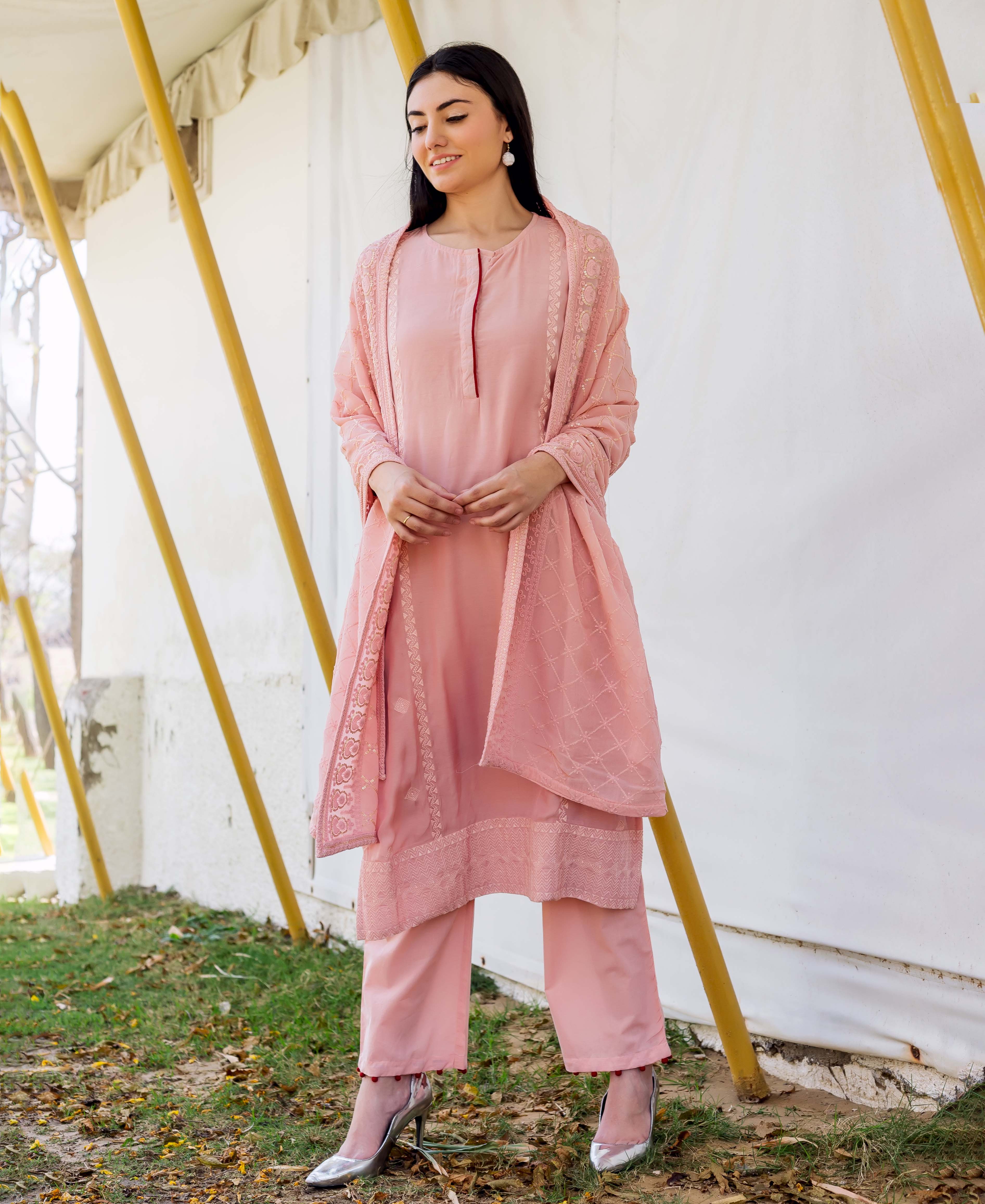 Full-body shot of model in dusty pink embroidered straight kurta, trousers, and patterned dupatta.