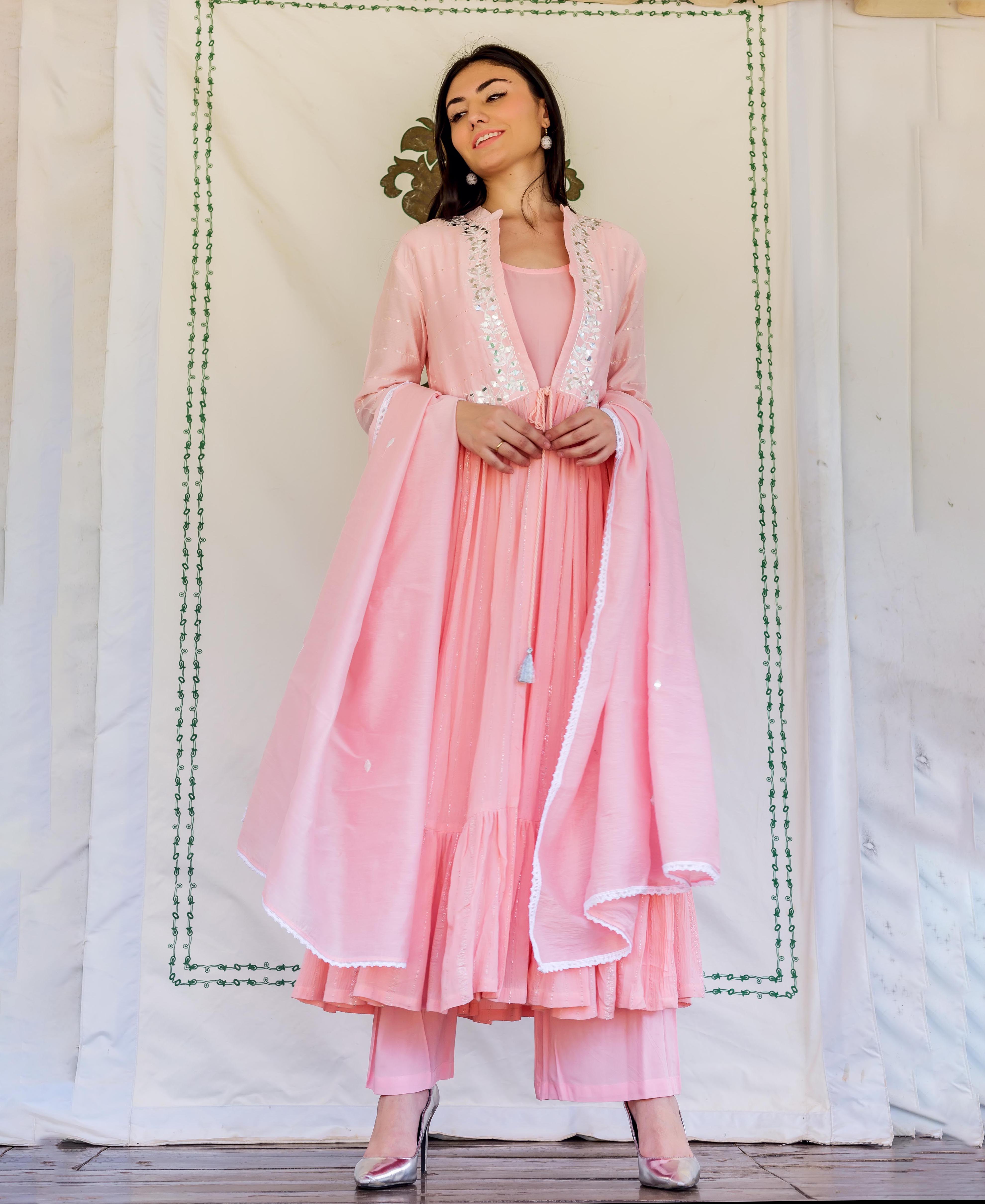 Full shot of model in a flamingo pink embroidered kurta with silver mirror work.
