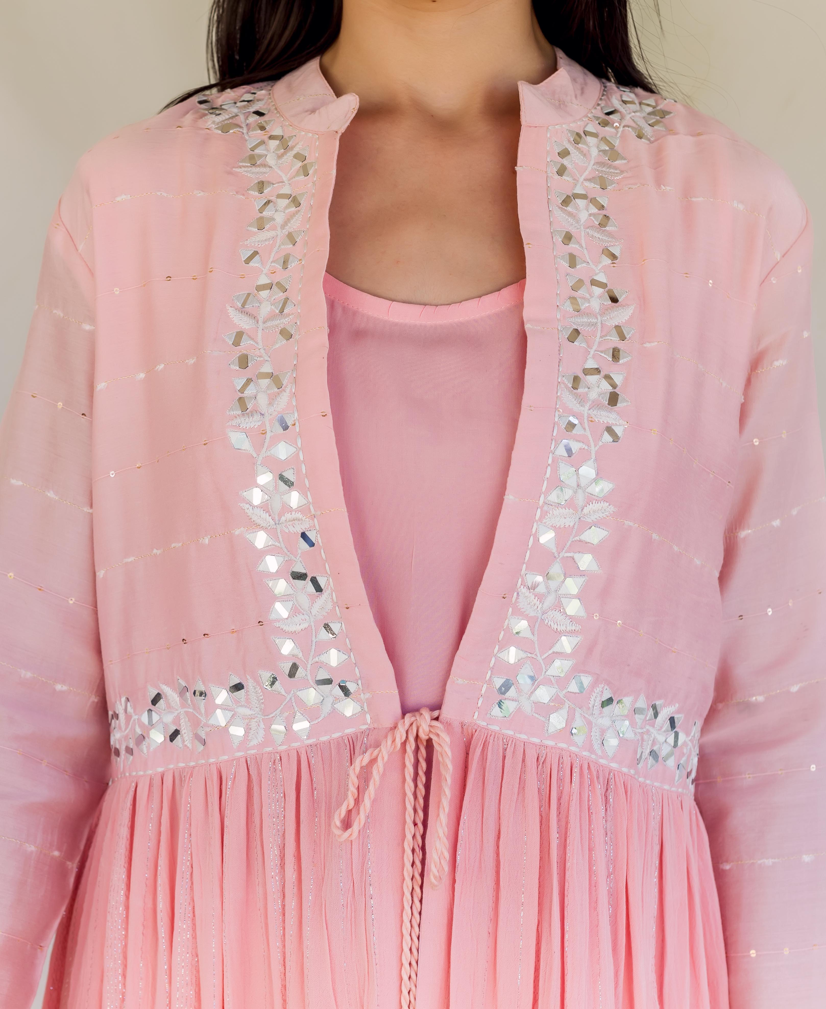 Front close-up of a model wearing a flamingo pink open embroidered kurta with mirror work.