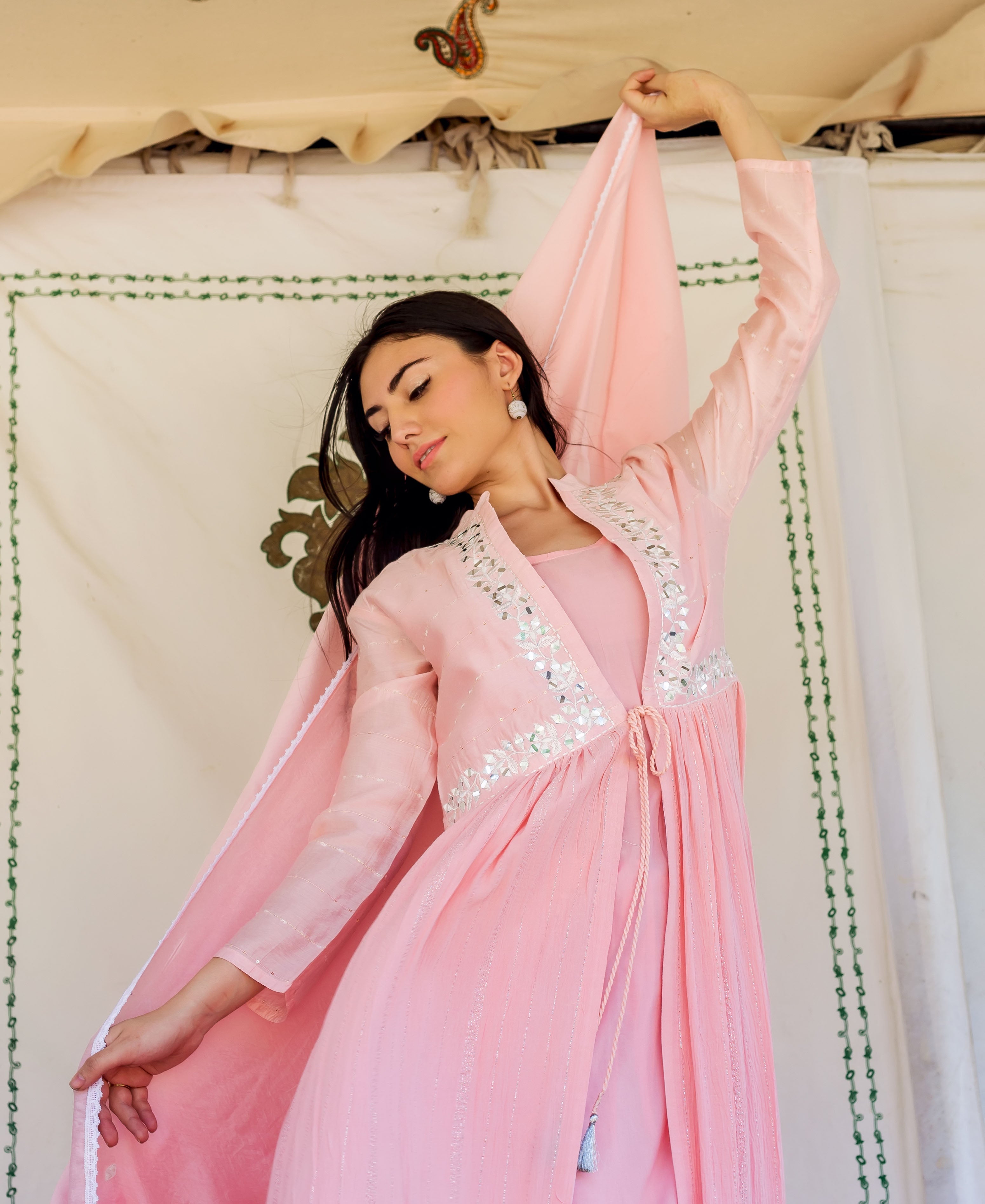 Flamingo pink embroidered kurta set with mirror work jacket on a gracefully posed model.