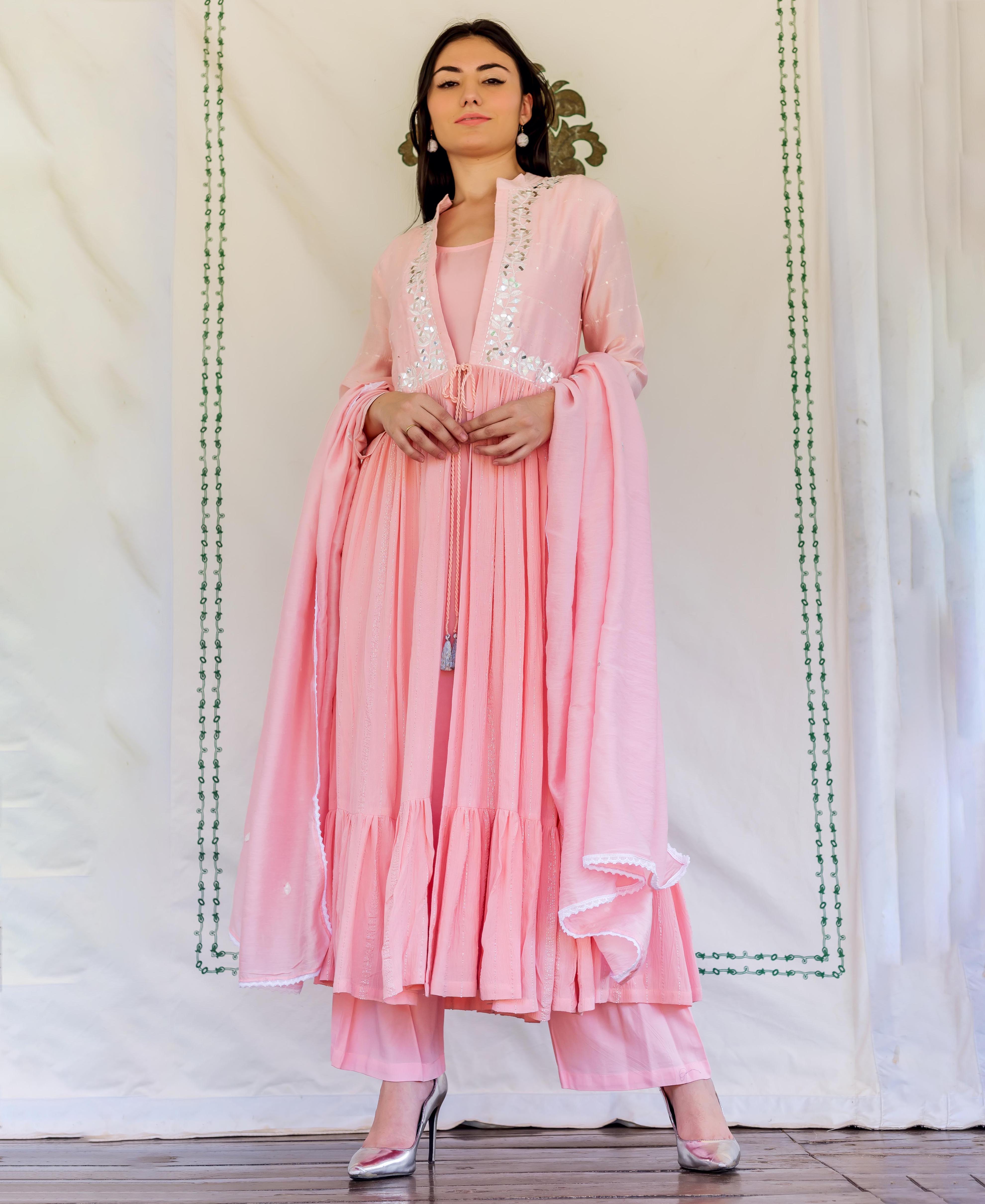 Flamingo pink embroidered kurta set with ruffled hem on a model, full-length front view.
