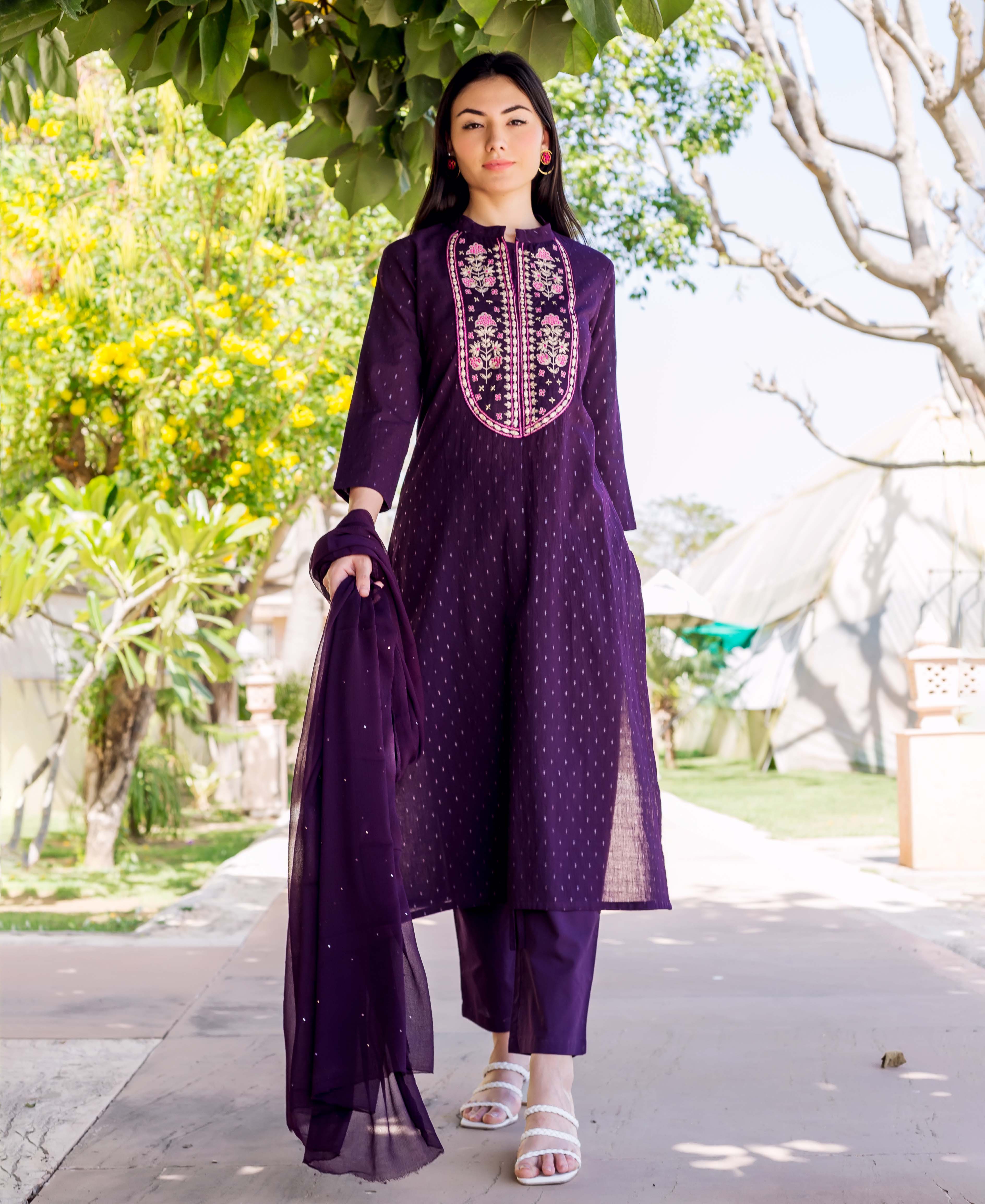 Model in a wine lurex embroidered straight kurta set with pants and matching dupatta.