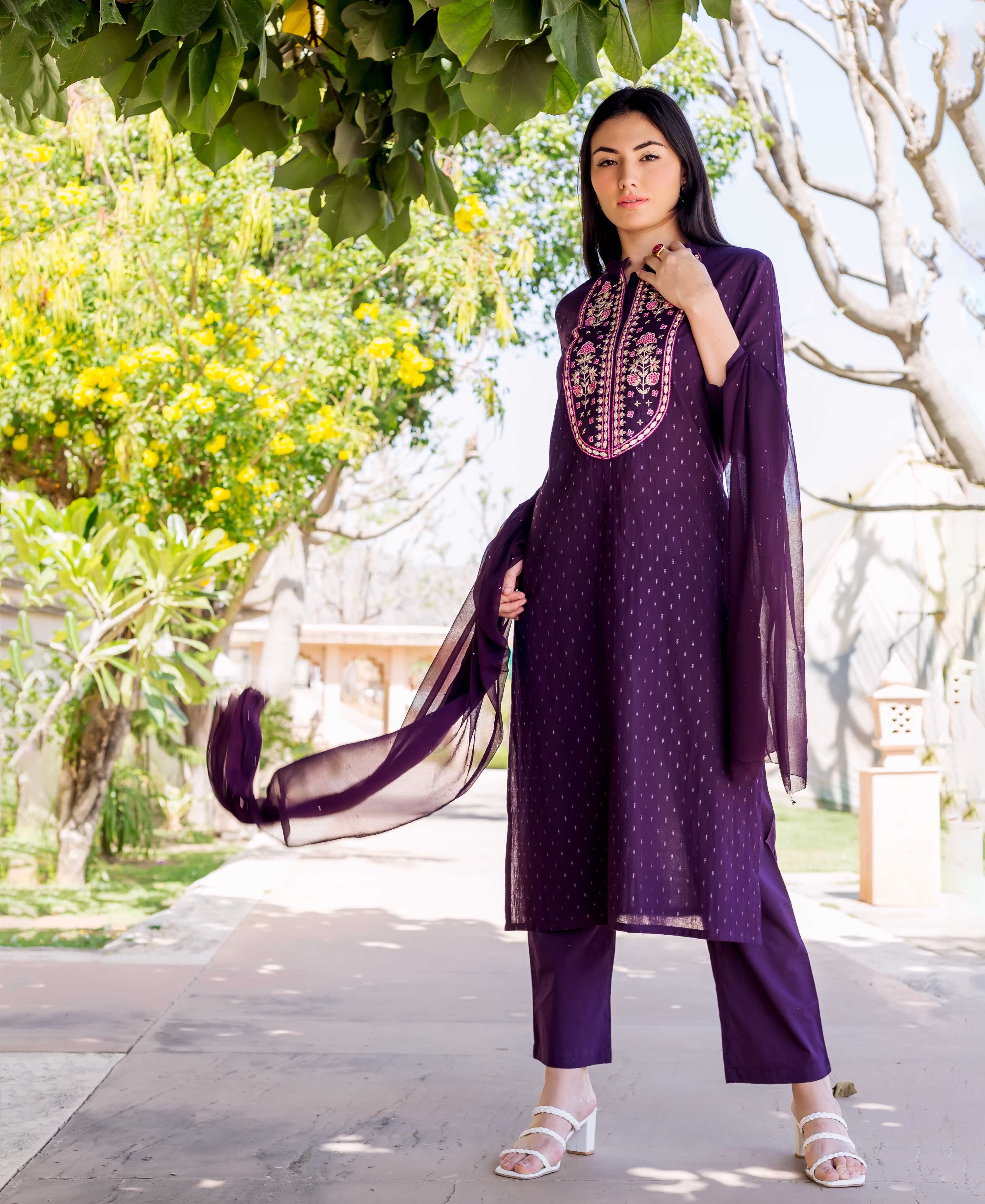 Full shot of model wearing a wine lurex dotted straight kurta with pink and gold embroidery.