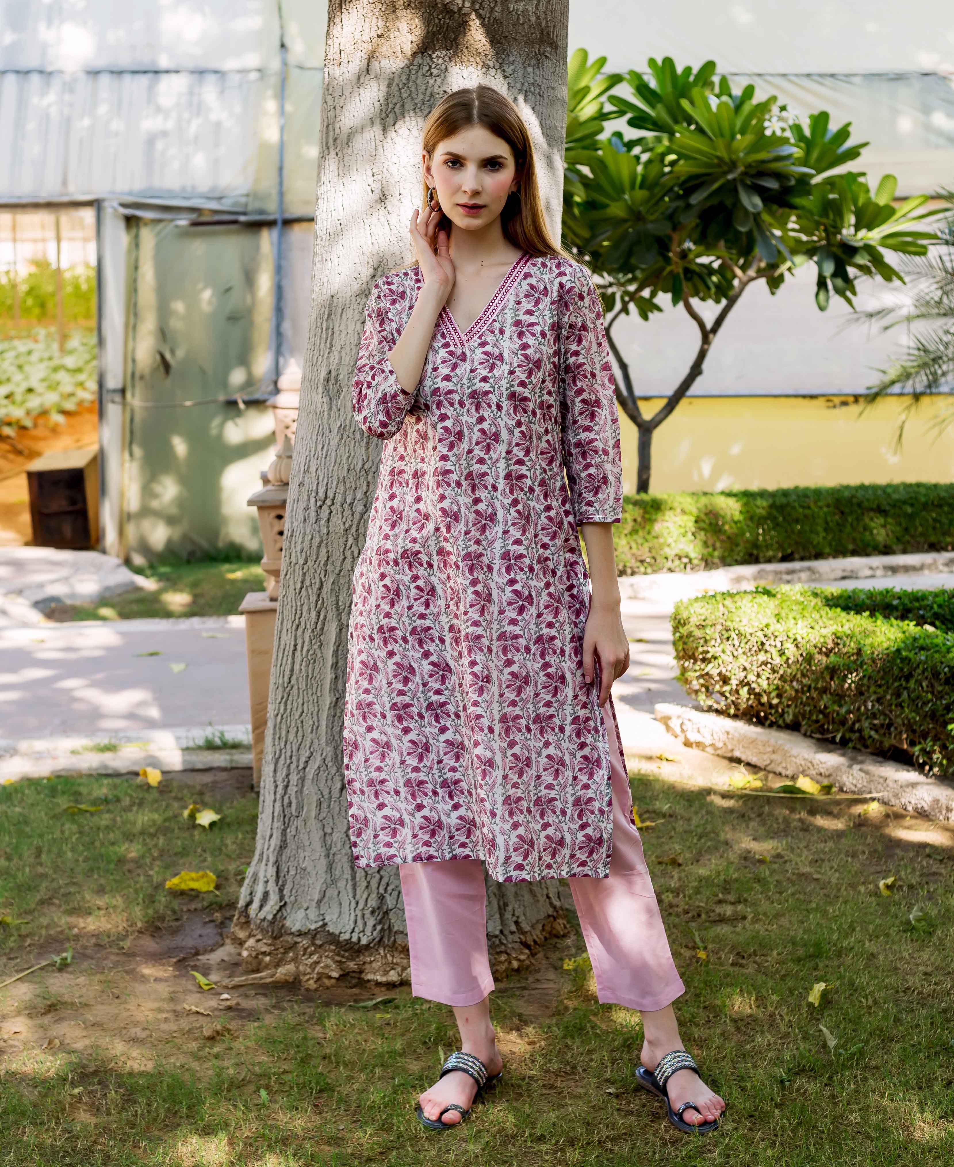 Full-length model in a pink hand-block printed floral kurta and light pink cropped pants.