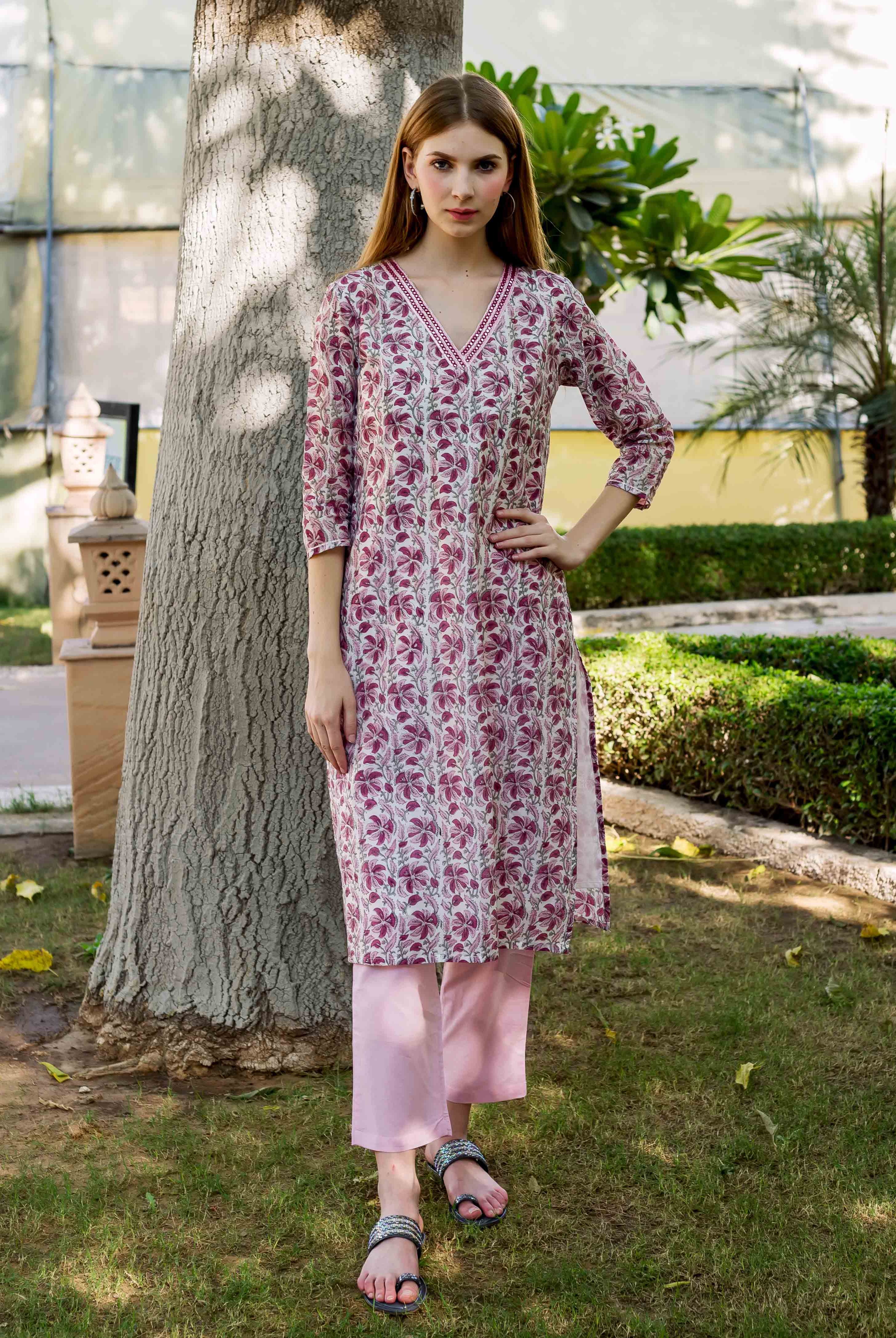 Full-length model wearing a pink and white floral hand-block printed kurta and pants.