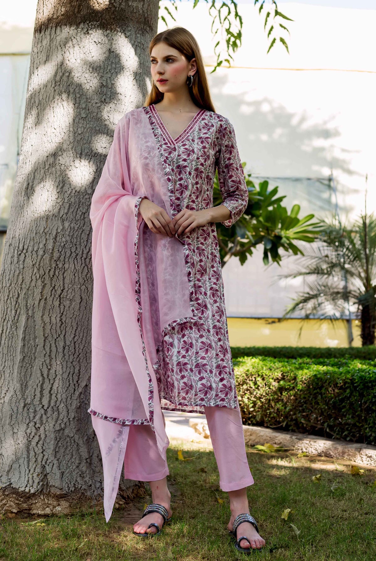 Full-body shot of model wearing a pink floral hand-block-printed Zahreen Kurta set.