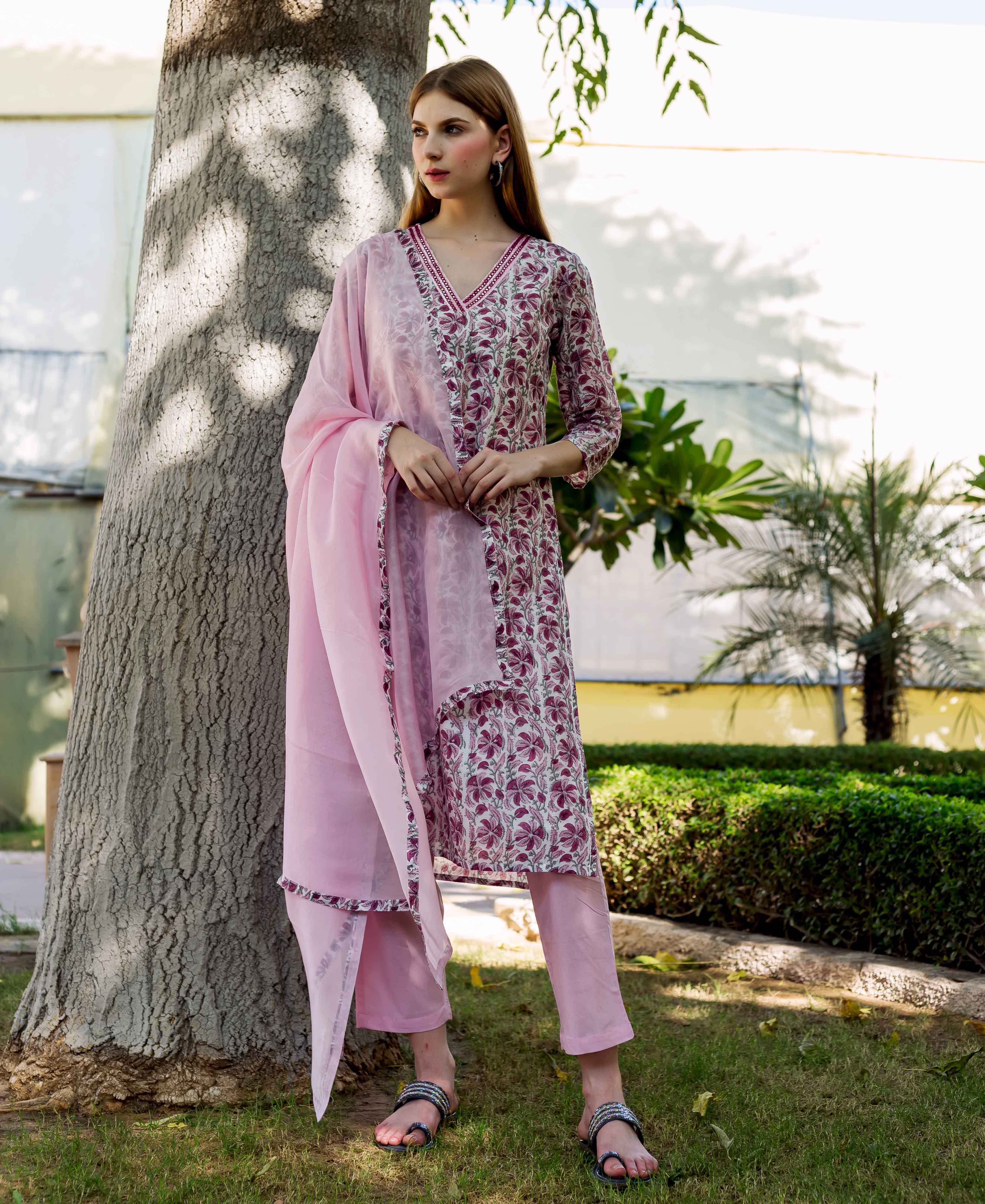 Full-body shot of model wearing a pink floral hand-block-printed Zahreen Kurta set.